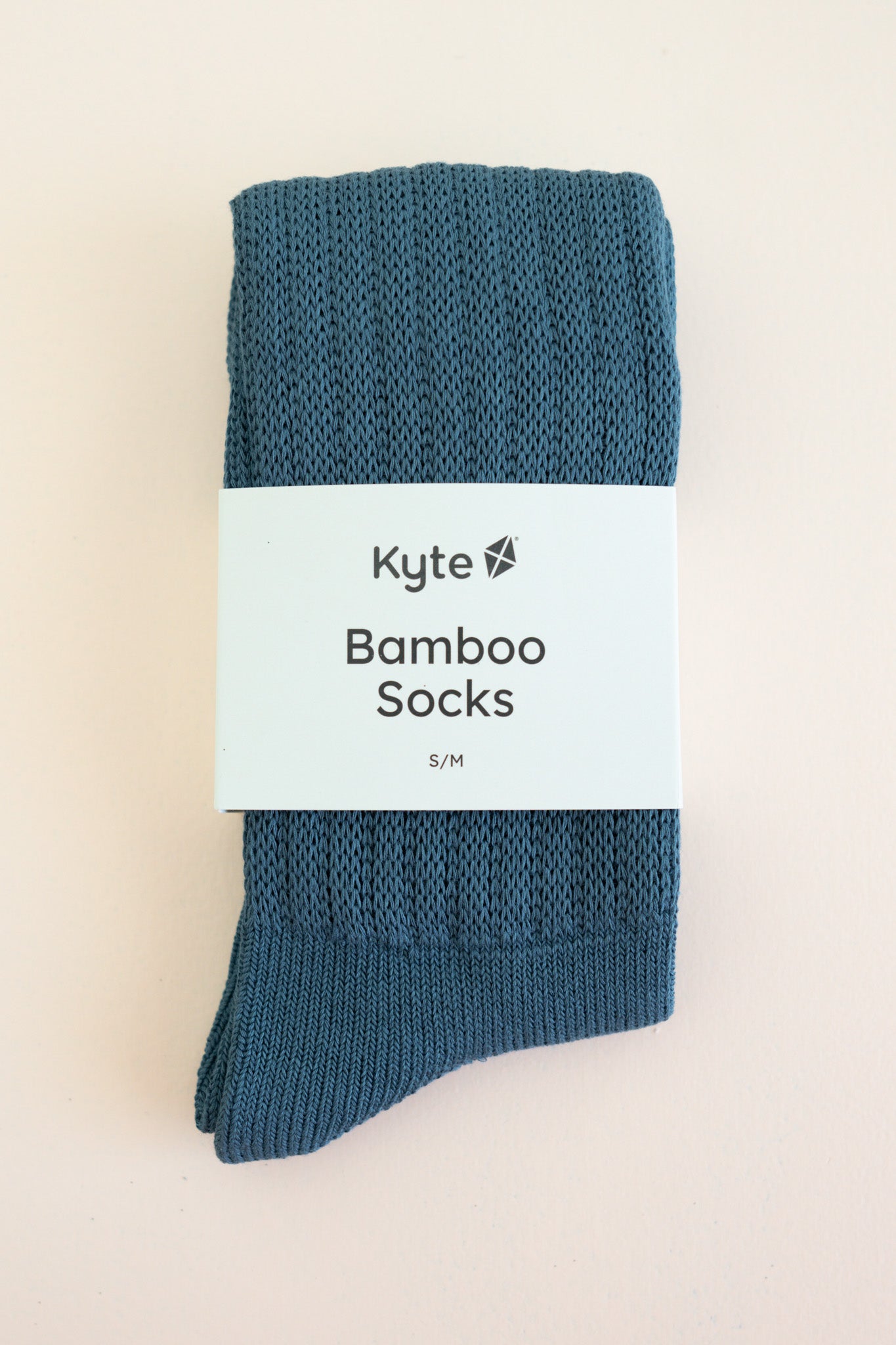 Adult Scrunch Socks in Atlantic shown in its packaging laying on a light neutral background