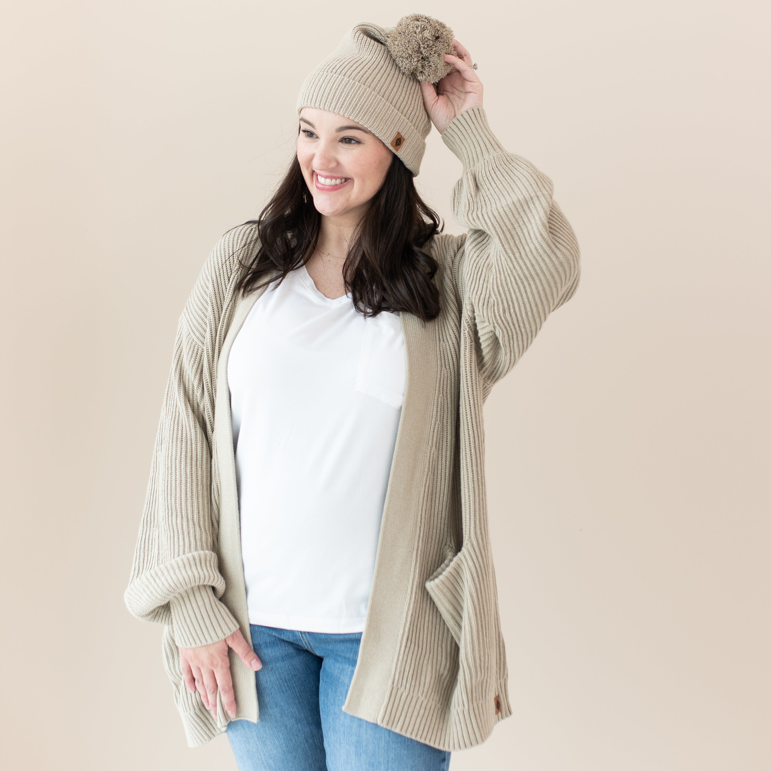 Woman wearing Chunky Knit Adult Pom Beanie in Almond and matching cardigan