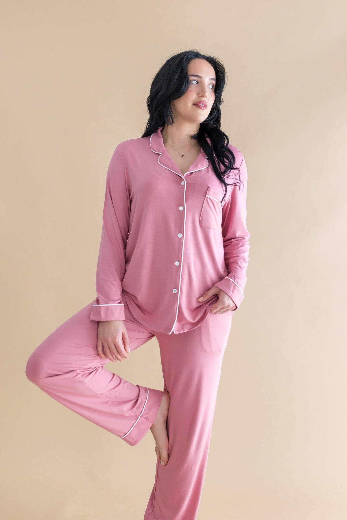 Female model posing wearing the Long-Sleeved Women's Pajama Set in Apple Blossom with Cloud Trim
