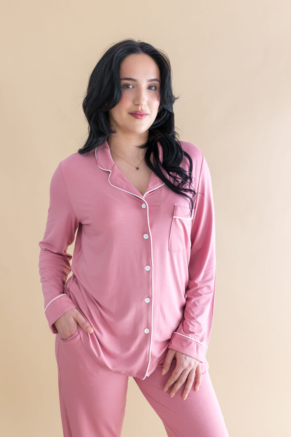 Female modeling the Long-Sleeved Women's Pajama Set in Apple Blossom with Cloud Trim in front of a light taupe background