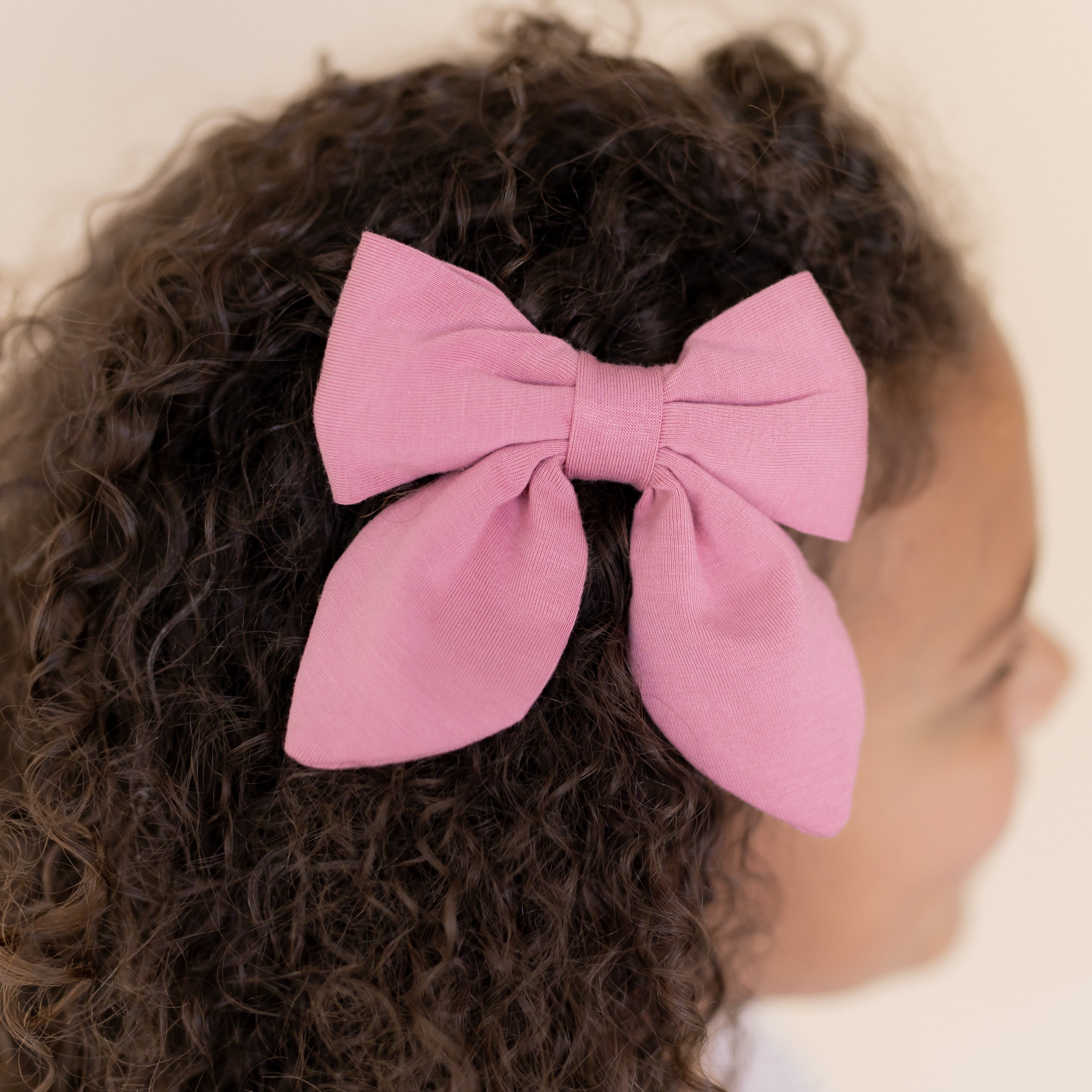 Medium Alligator Clip Bow in Apple Blossom shown in a young girls hair