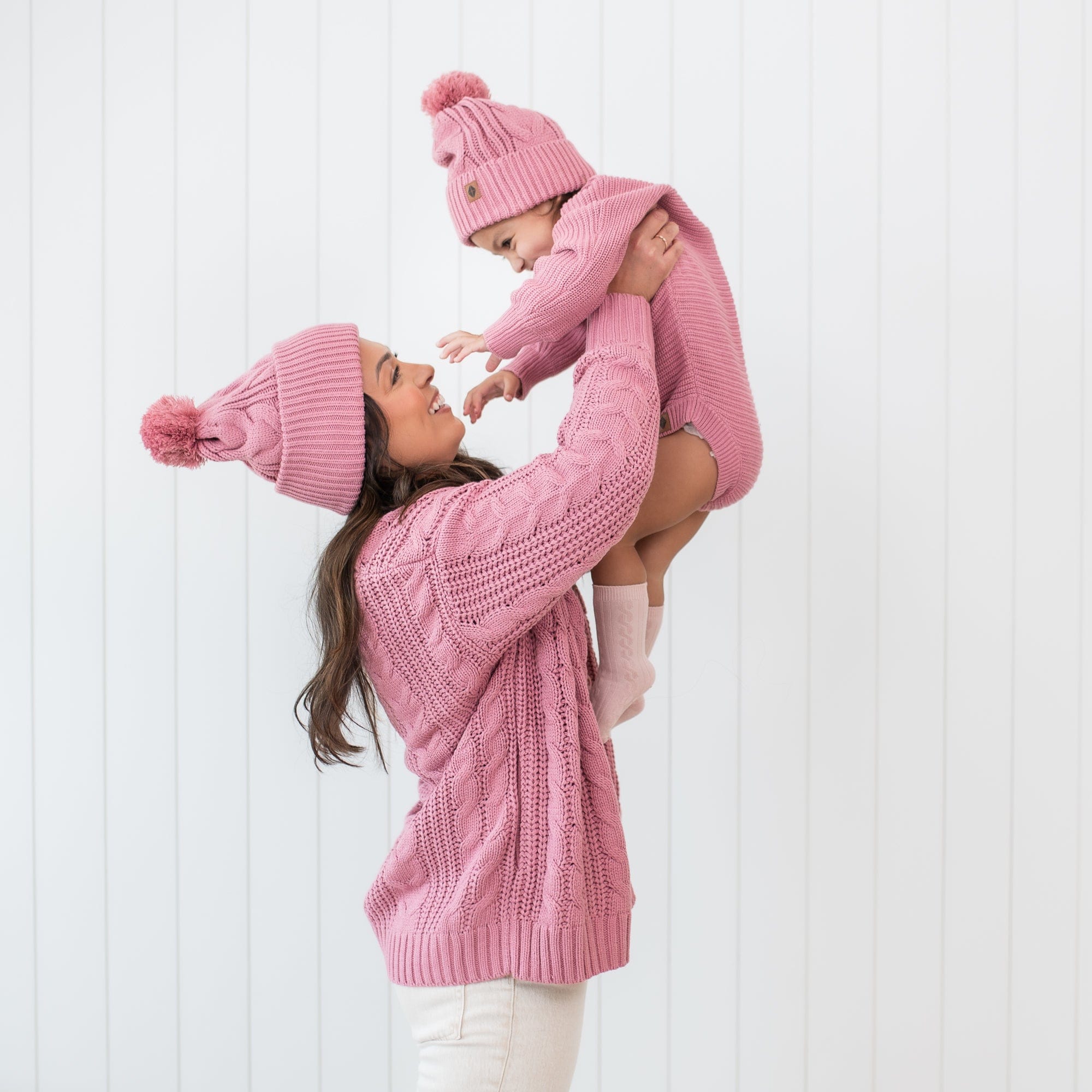 Mother and daughter wearing matching Chunky Cable Knit Beanies in Apple Blossom