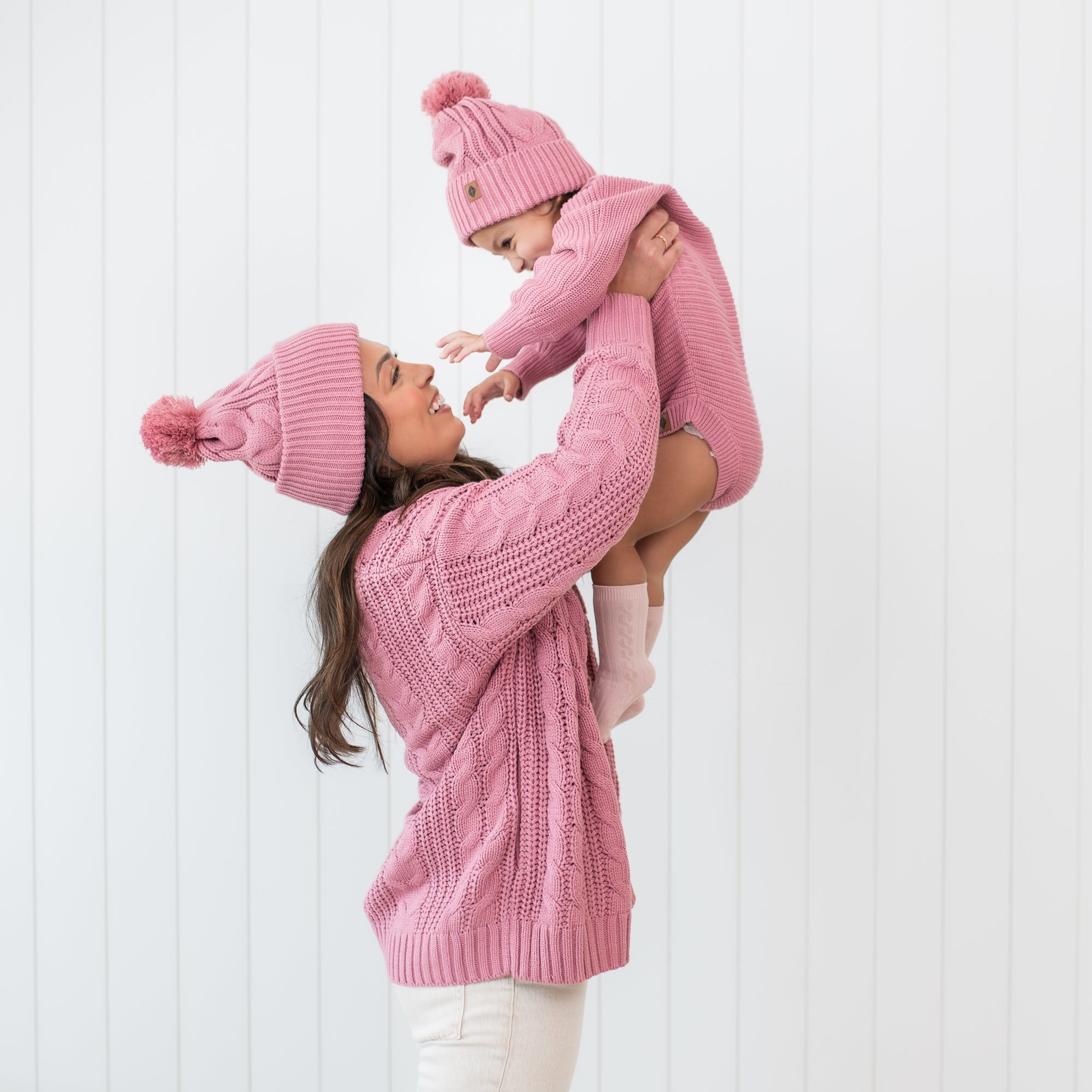 Mother and daughter wearing matching Chunky Cable Knit Beanies in Apple Blossom