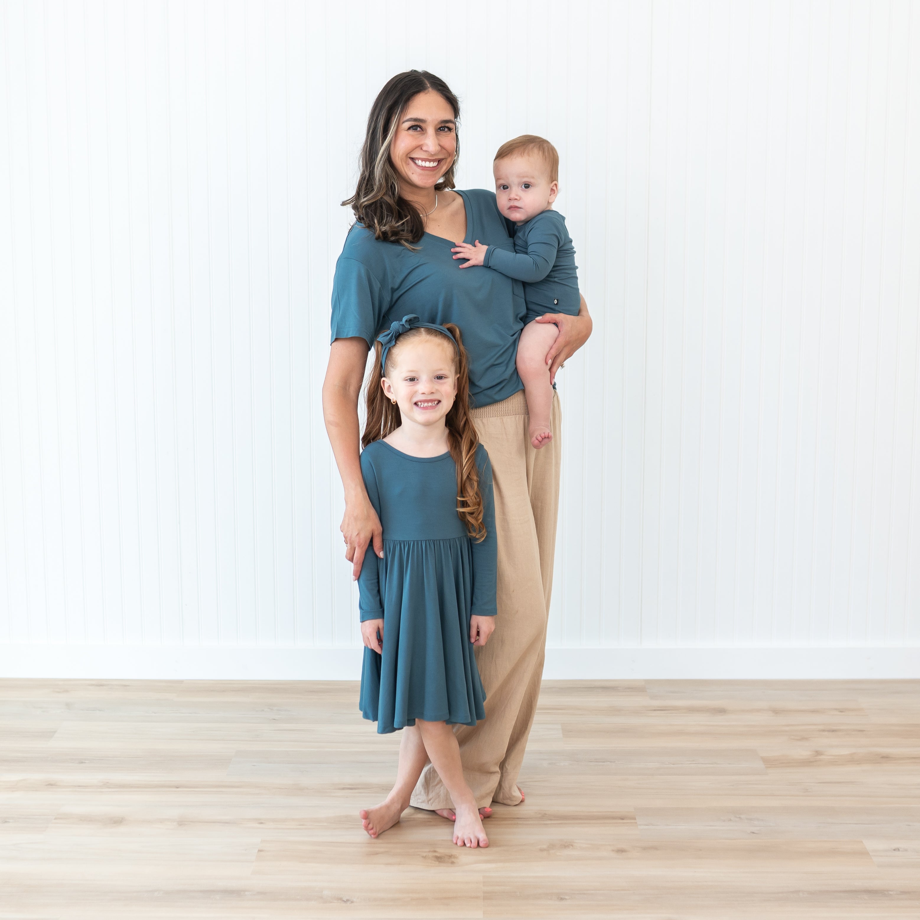 Family matching in the Atlantic color from our Fall collection. Pictures is the Women's V-Neck, Long Sleeve Twirl dress and Long Sleeve Bodysuit in Atlantic