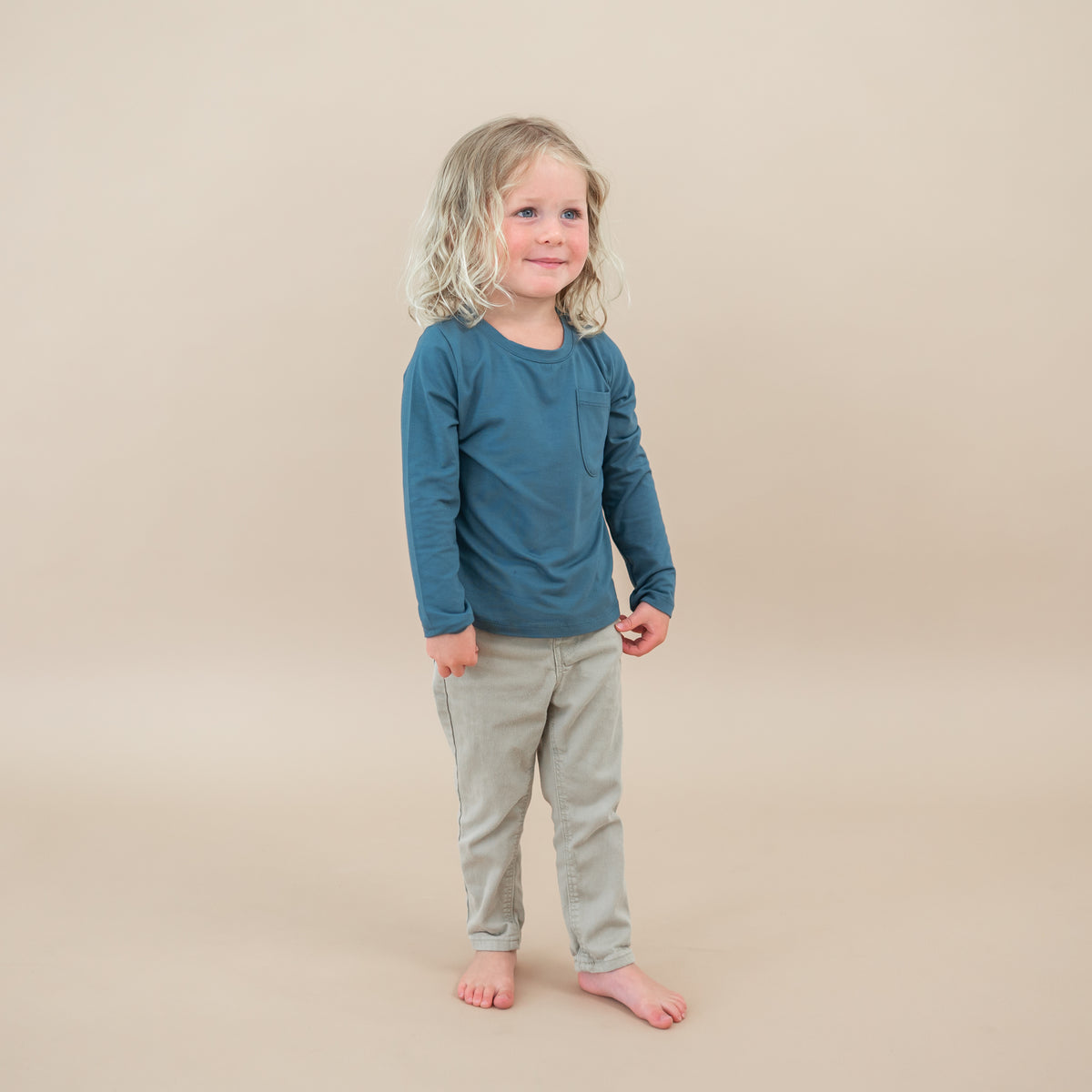 Toddler wearing the Long Sleeve Toddler Crew Neck Tee in Atlantic paired with jeans