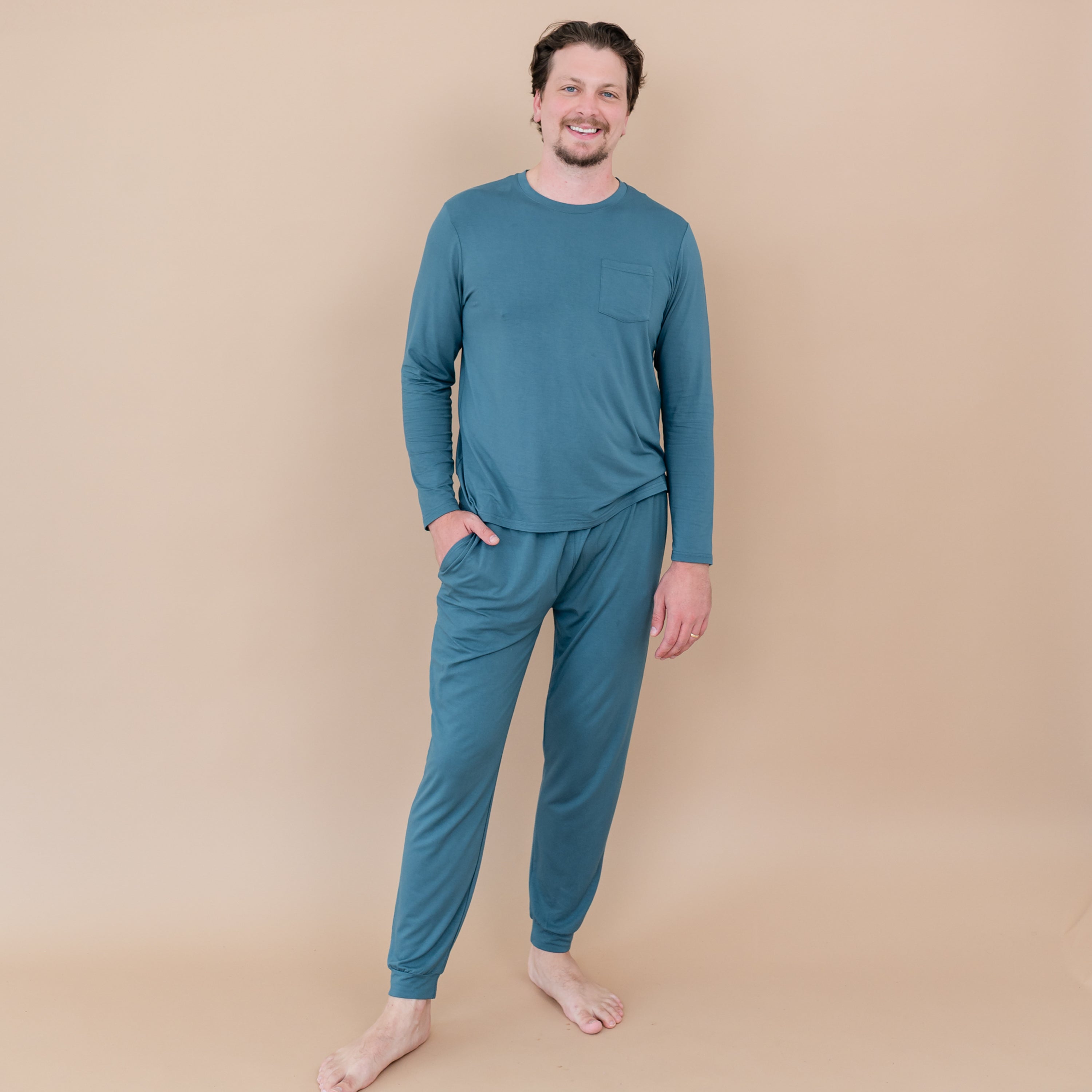 Male model standing wearing the Men's Jogger Set in Atlantic with one hand in the jogger pant pocket