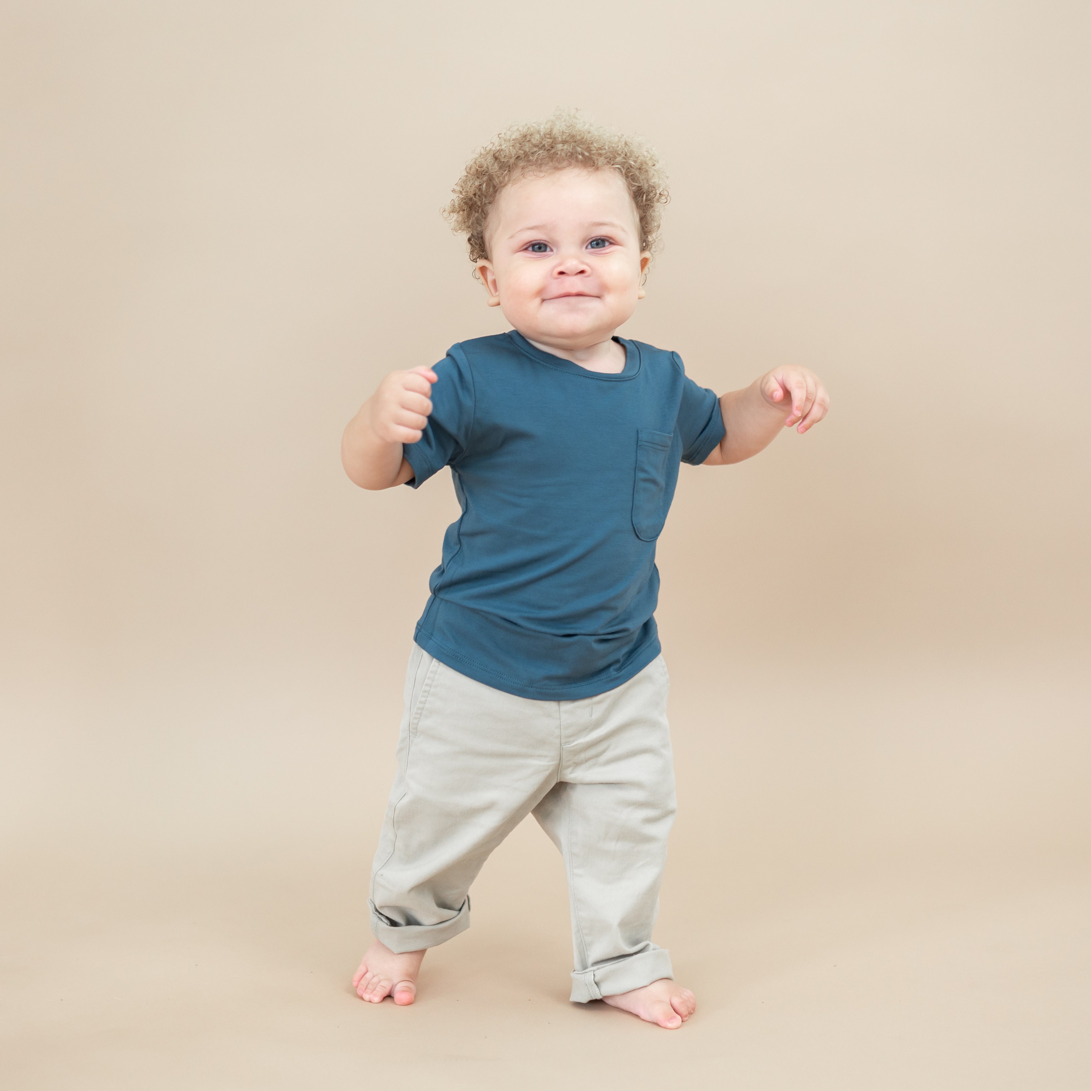 Toddler walking wearing the Toddler Crew Neck Tee in Atlantic with khaki colored pants