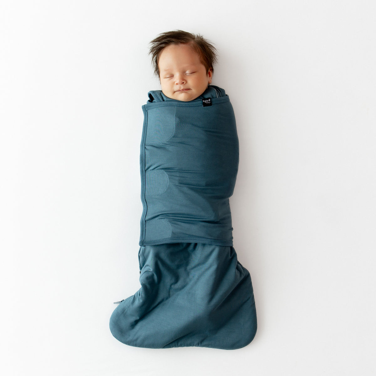 Sleeping infant swaddled in the Sleep Bag Swaddler in Atlantic 1.0