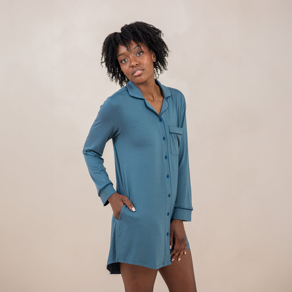 Female model standing with one hand in the pocket of the Long Sleeve Women’s Nightshirt in Atlantic