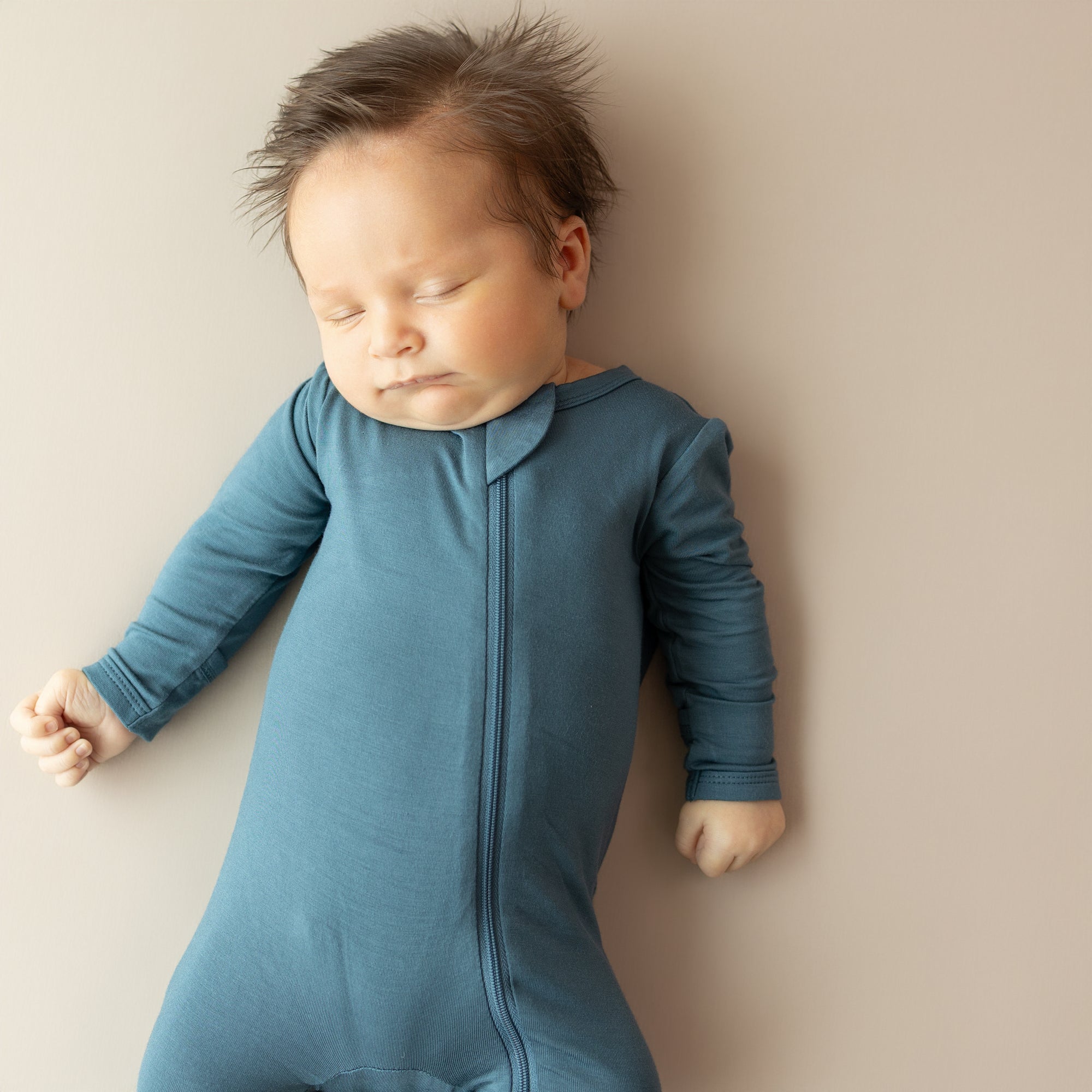 Close up of the Zippered Footie in Atlantic on a sleeping infant
