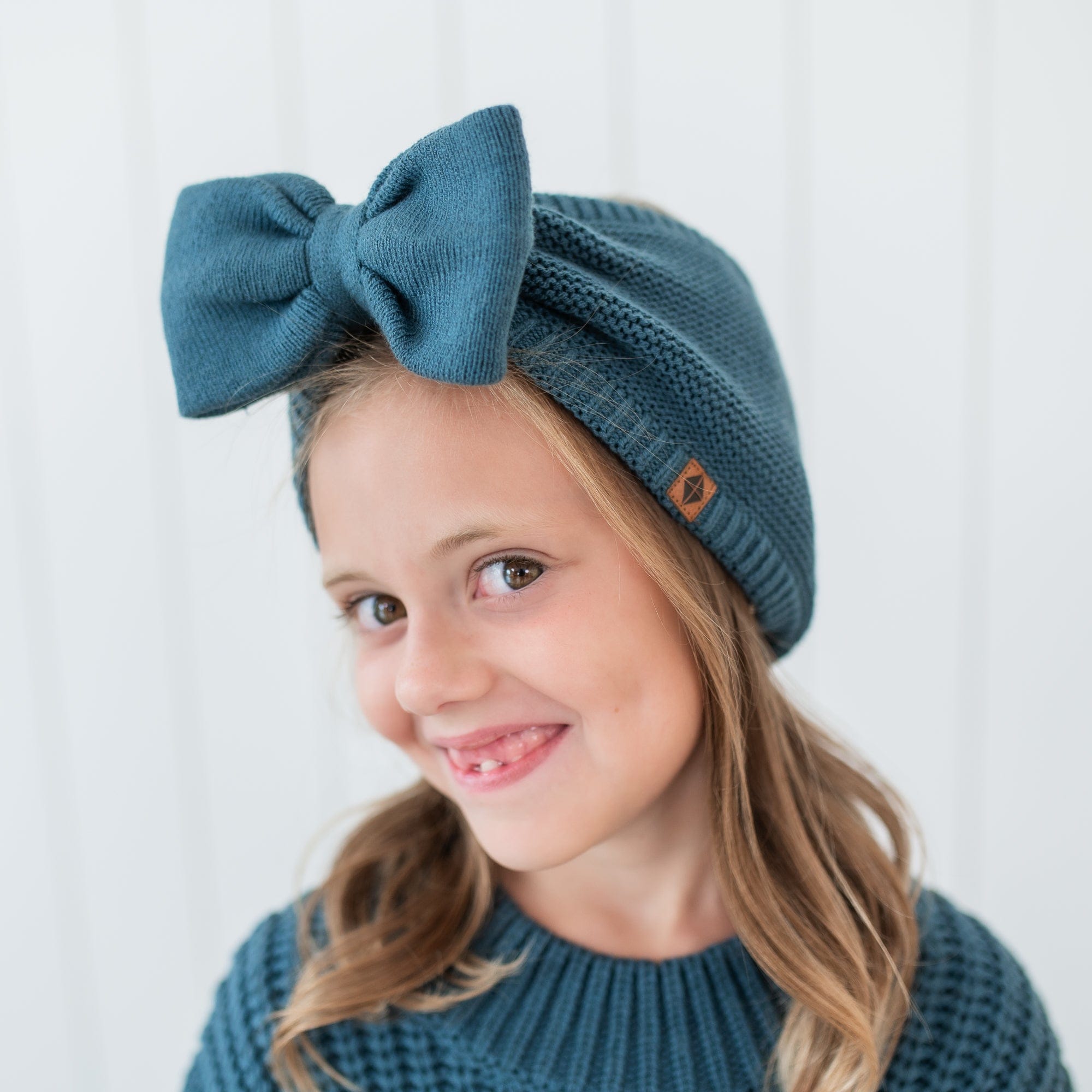 Chunky Knit Bow Headband in Atlantic shown on a young girl