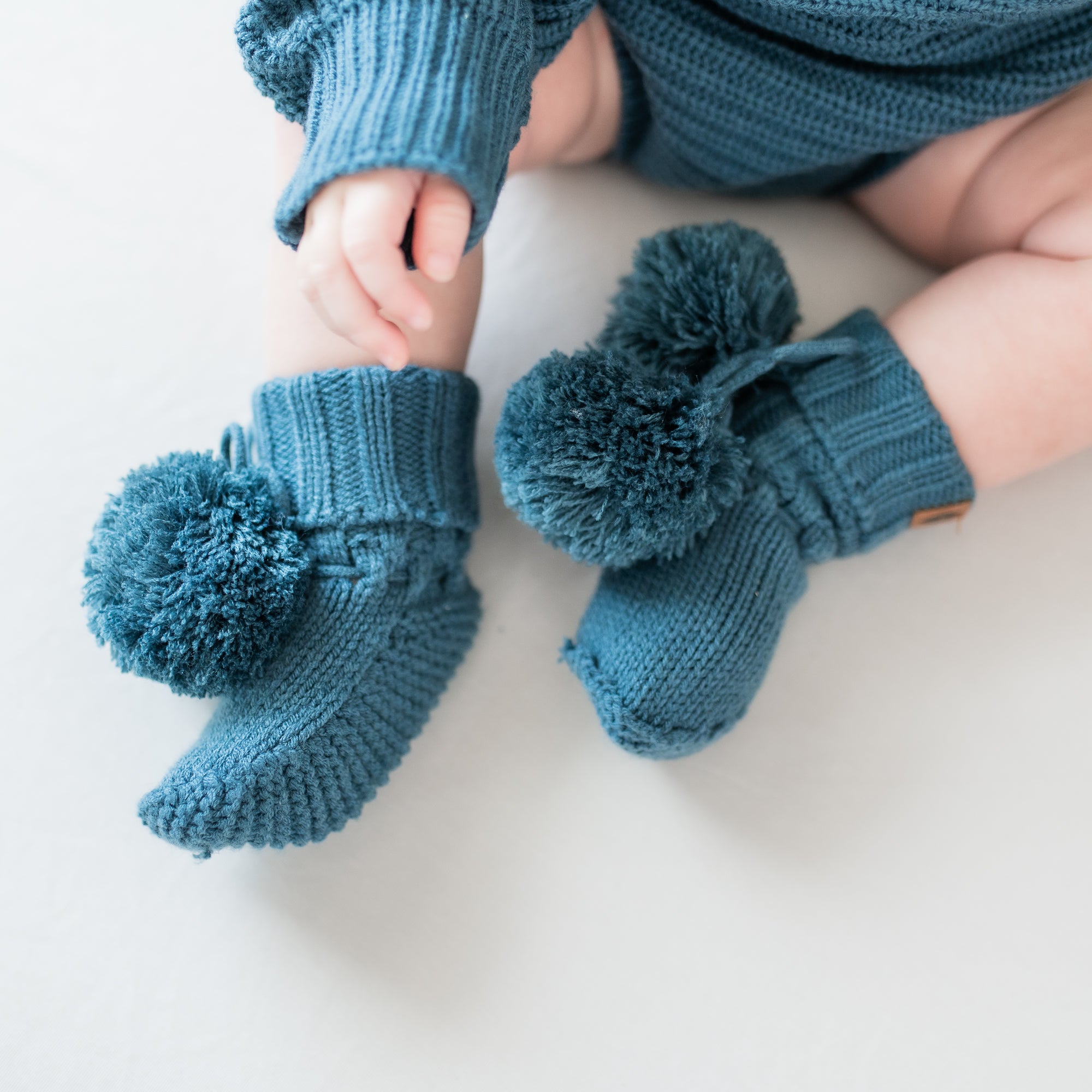 Knit Booties in Atlantic shown on an infant