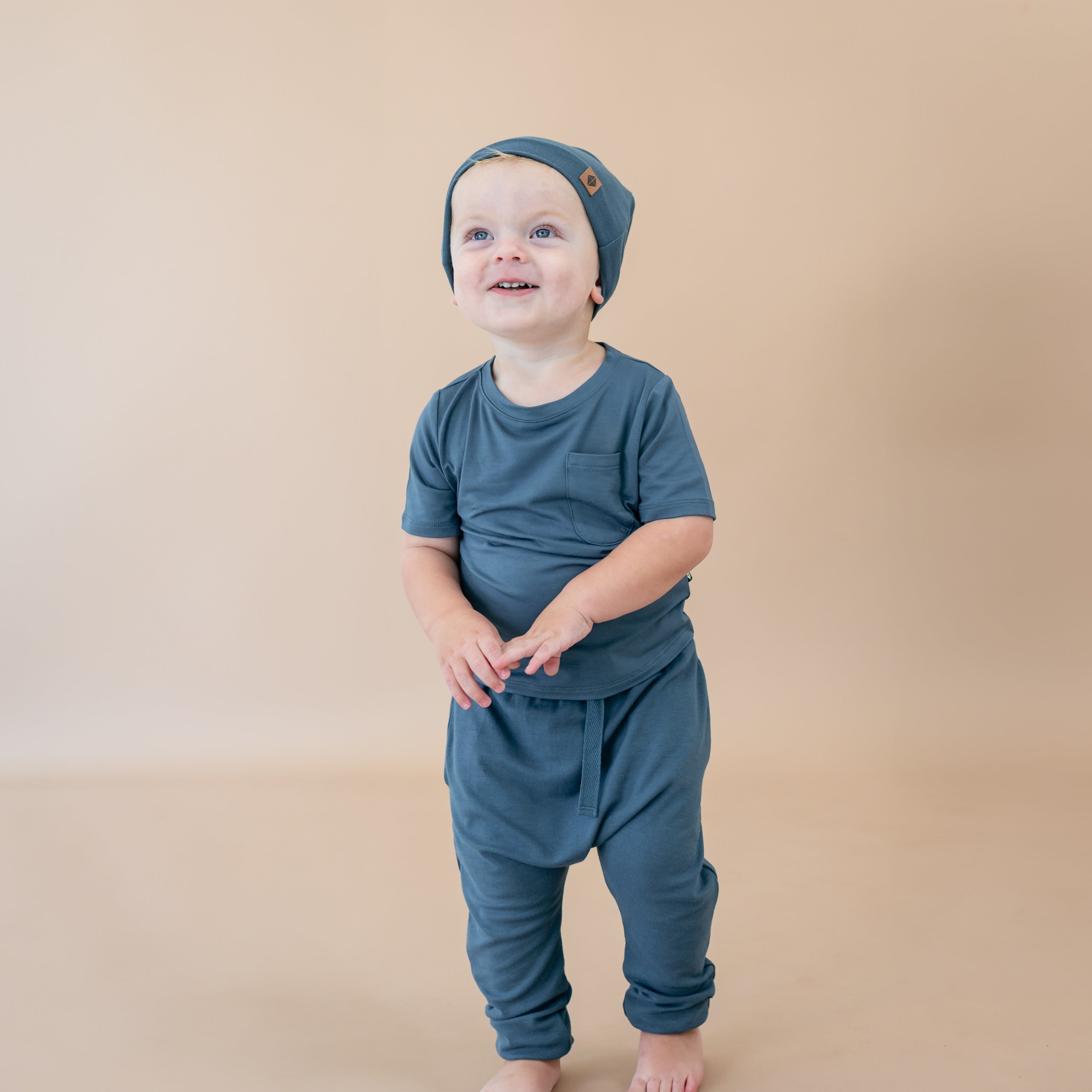 Toddler wearing Bamboo Jersey Beanie in Atlantic and matching short sleeve crew neck tee and harem pants