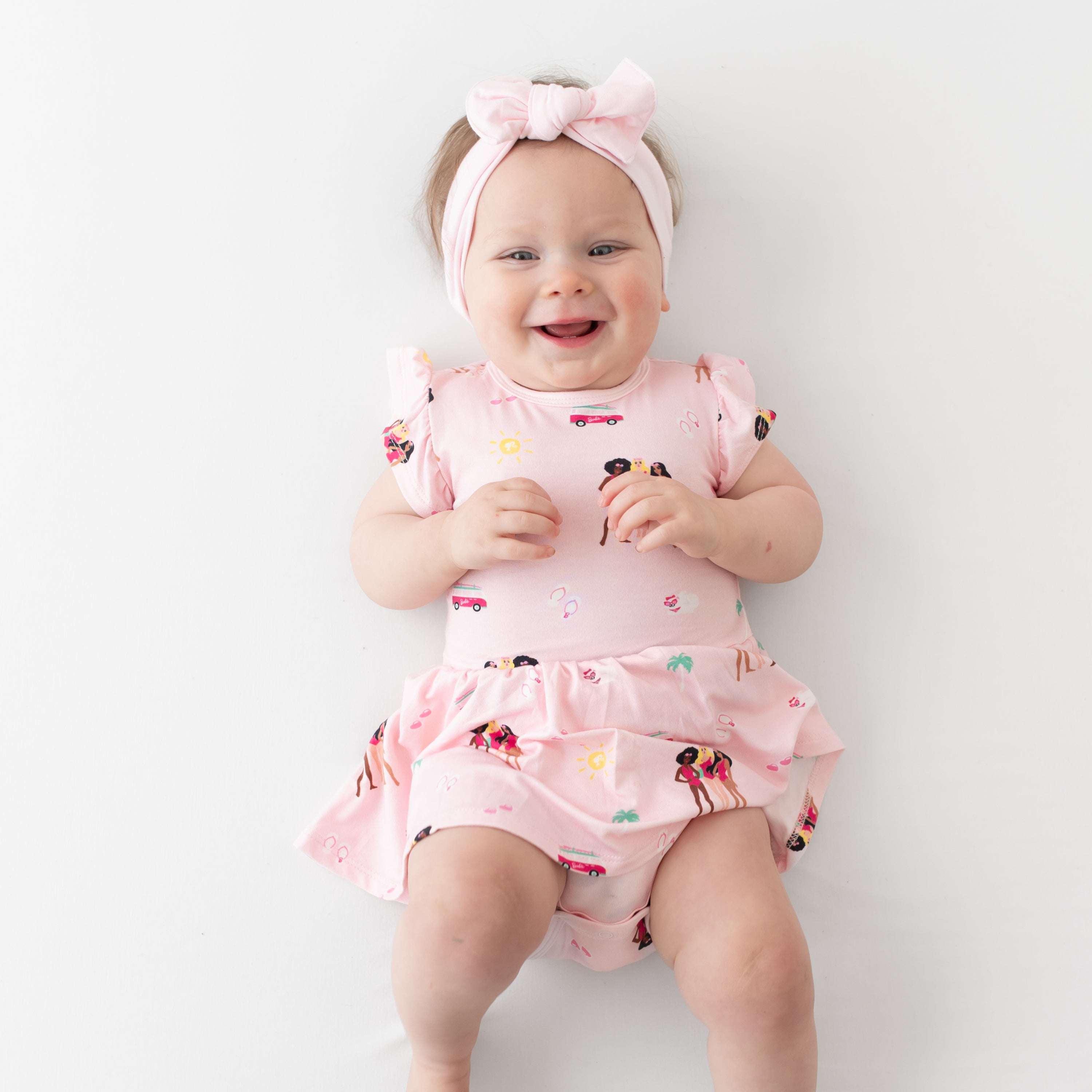 Baby wearing Twirl Bodysuit Dress in Barbie™ Beach
