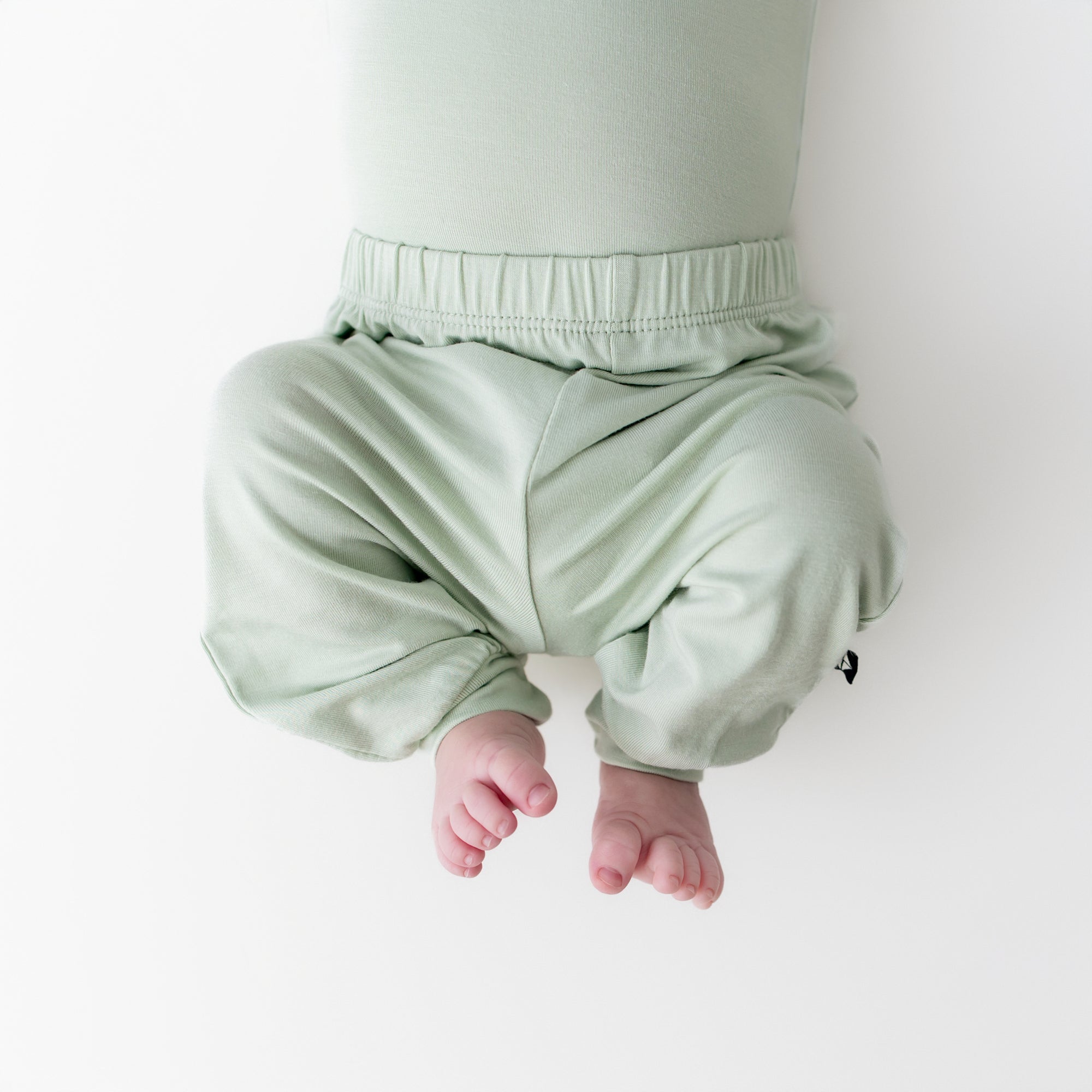 close up of the Pant in Basil on a newborn