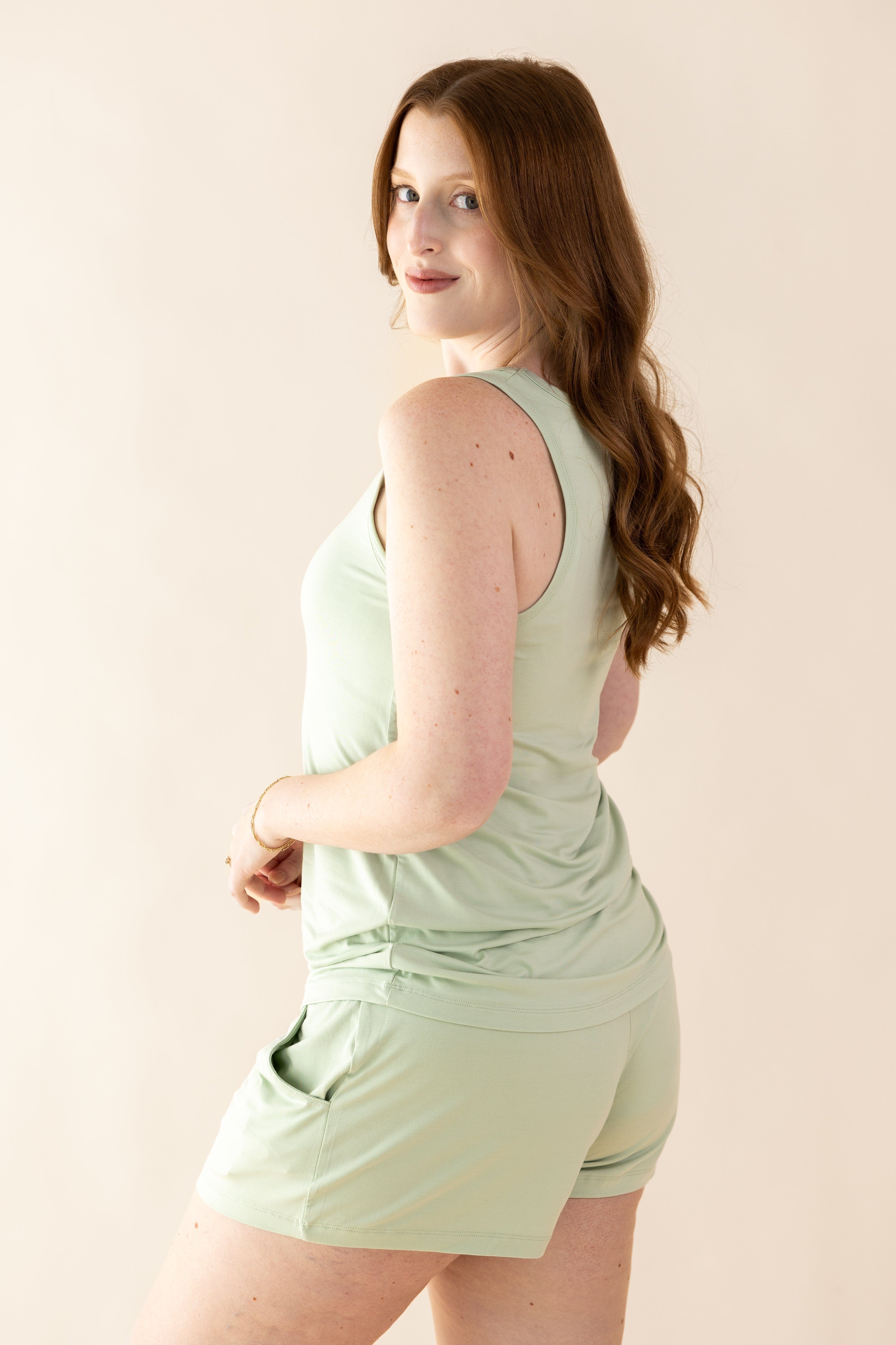 Female model posing wearing the Women's Tank Set in Basil