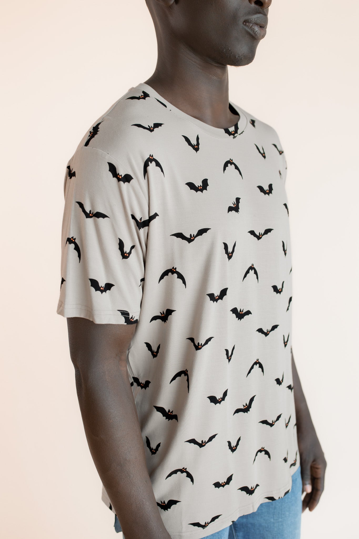 Close up of Modal wearing Men's Crew Neck Tee in Bats print on a beige background