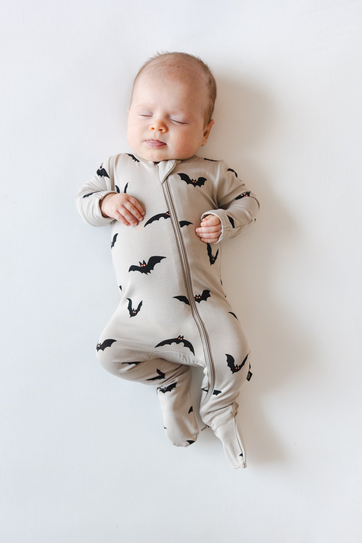Baby sleeping Zippered Footie in Bats print on a white background
