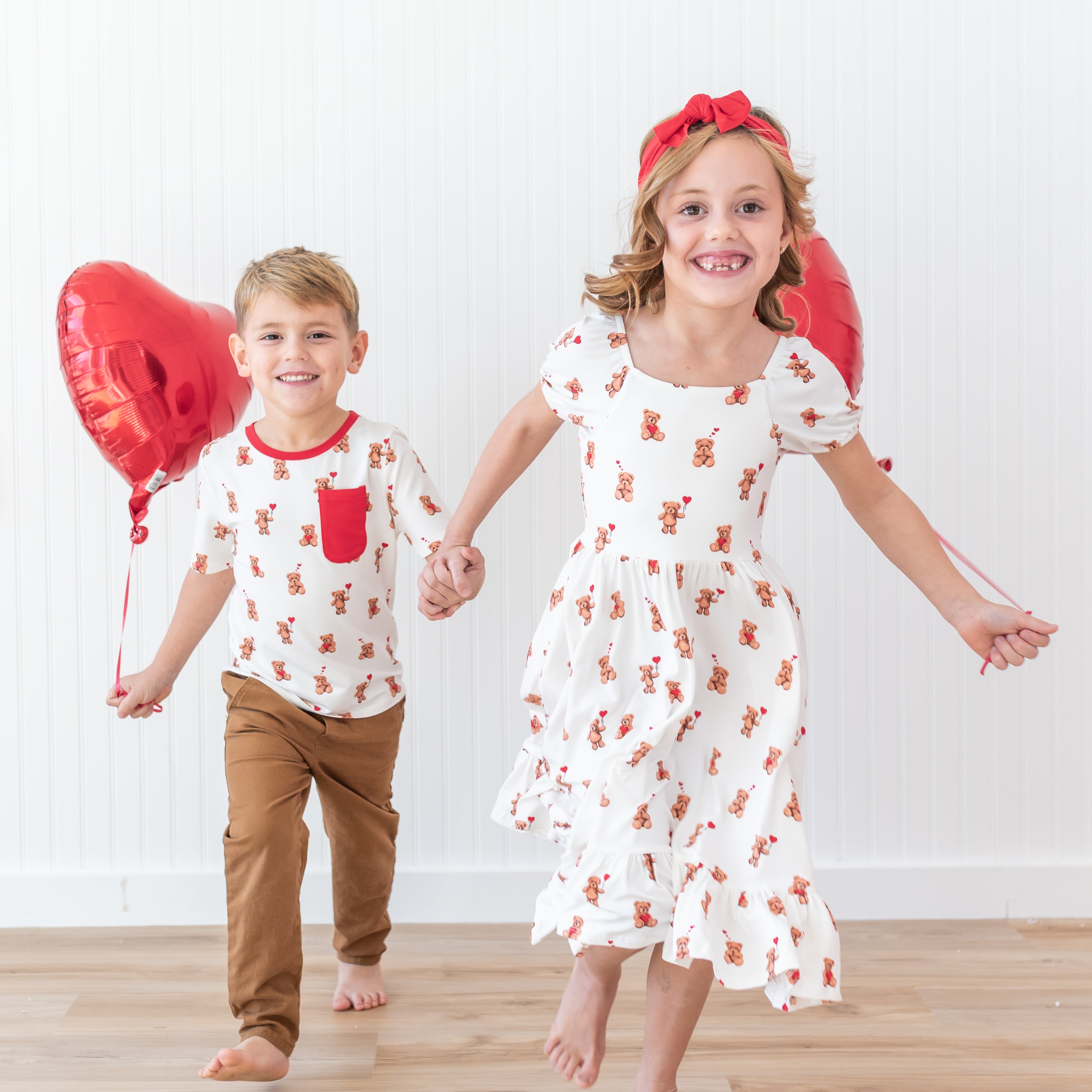 Brother and sister walking and holding hands matching in Puff Sleeve Twirl Dress in Bear Hearts and Crew Neck Tee Bear Hearts