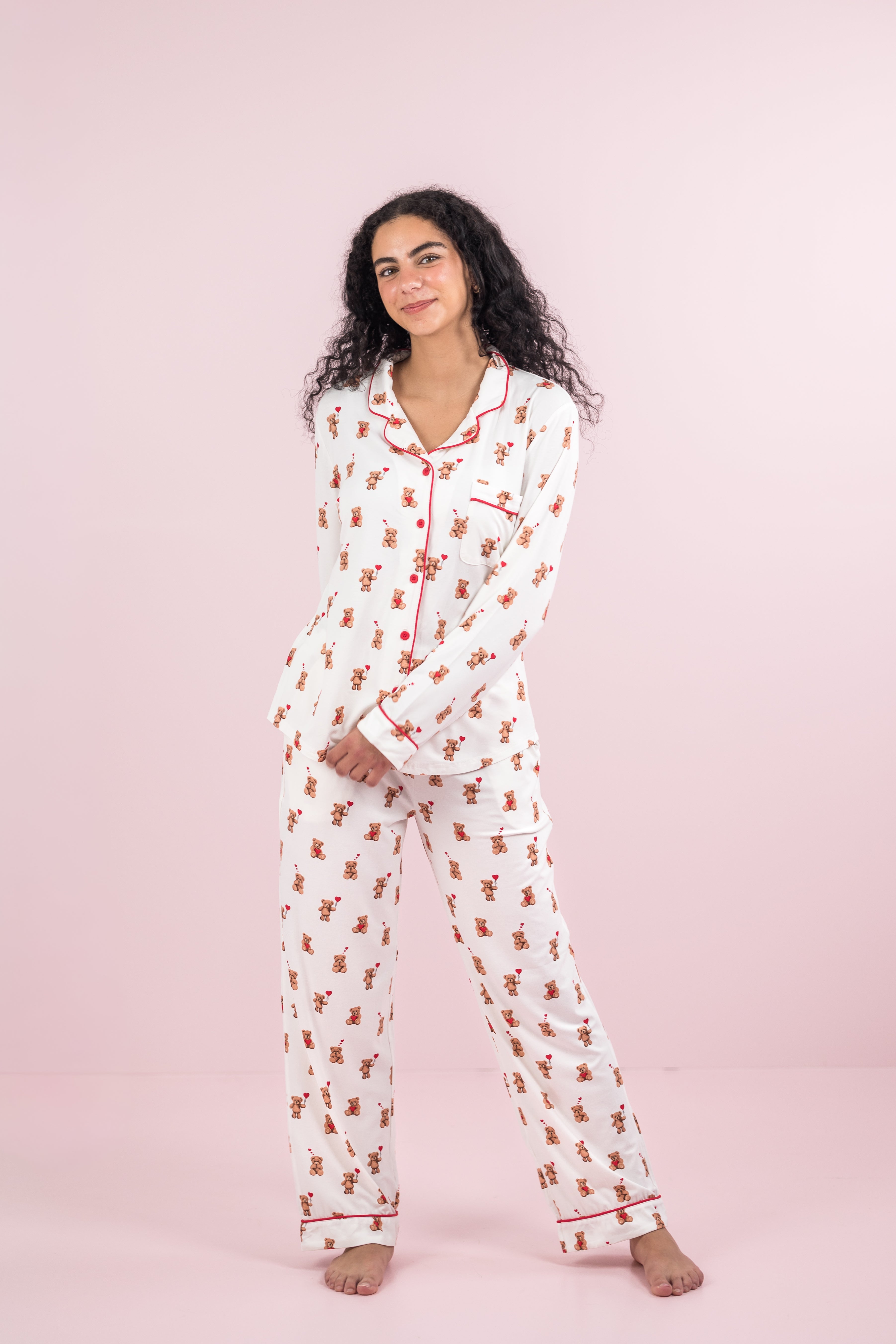 Female model posing wearing the Long-Sleeved Women's Pajama Set in Bear Hearts