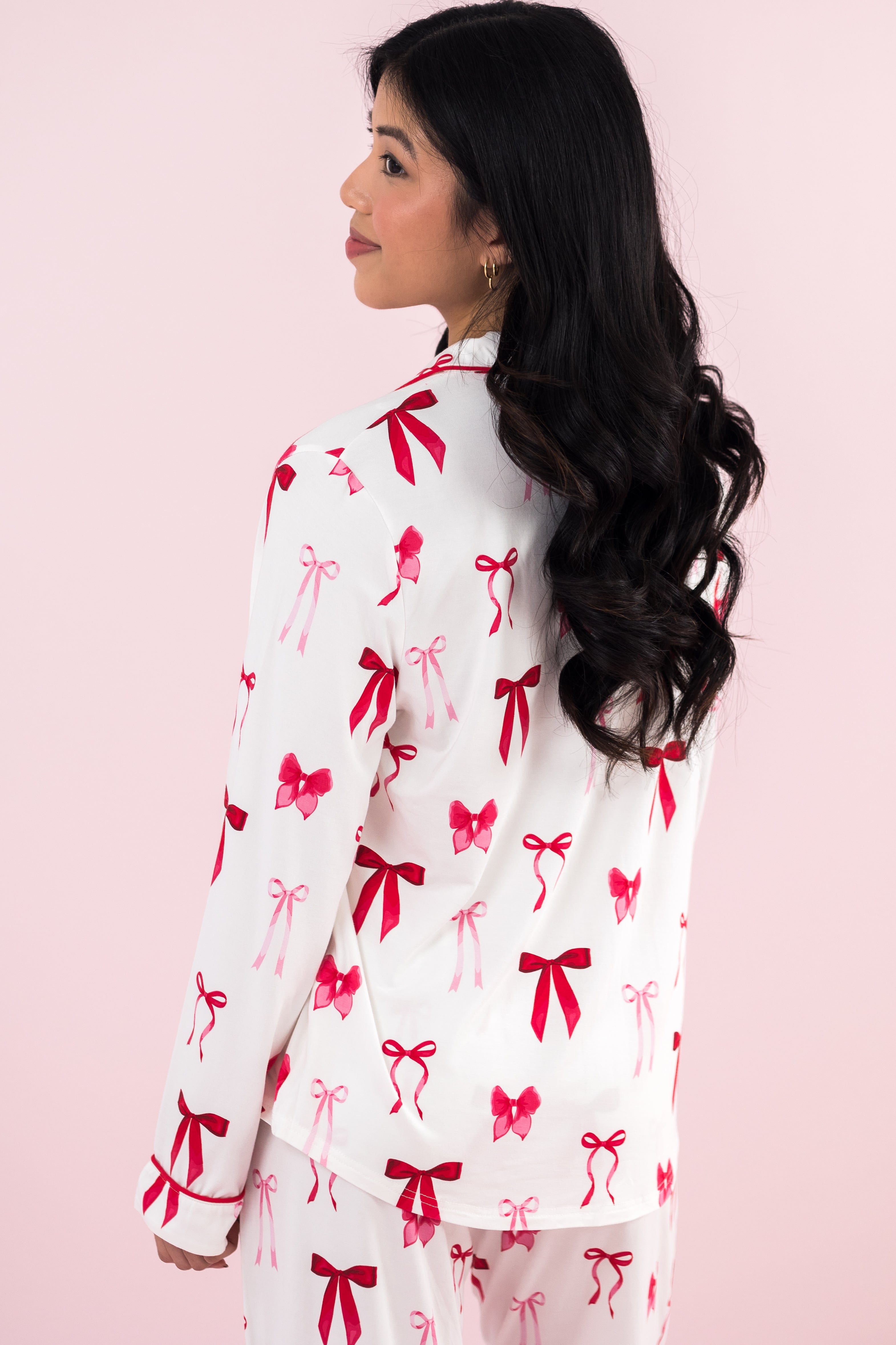 Model with her back to the camera wearing the Long-Sleeved Women's Pajama Set in Big Love Bow
