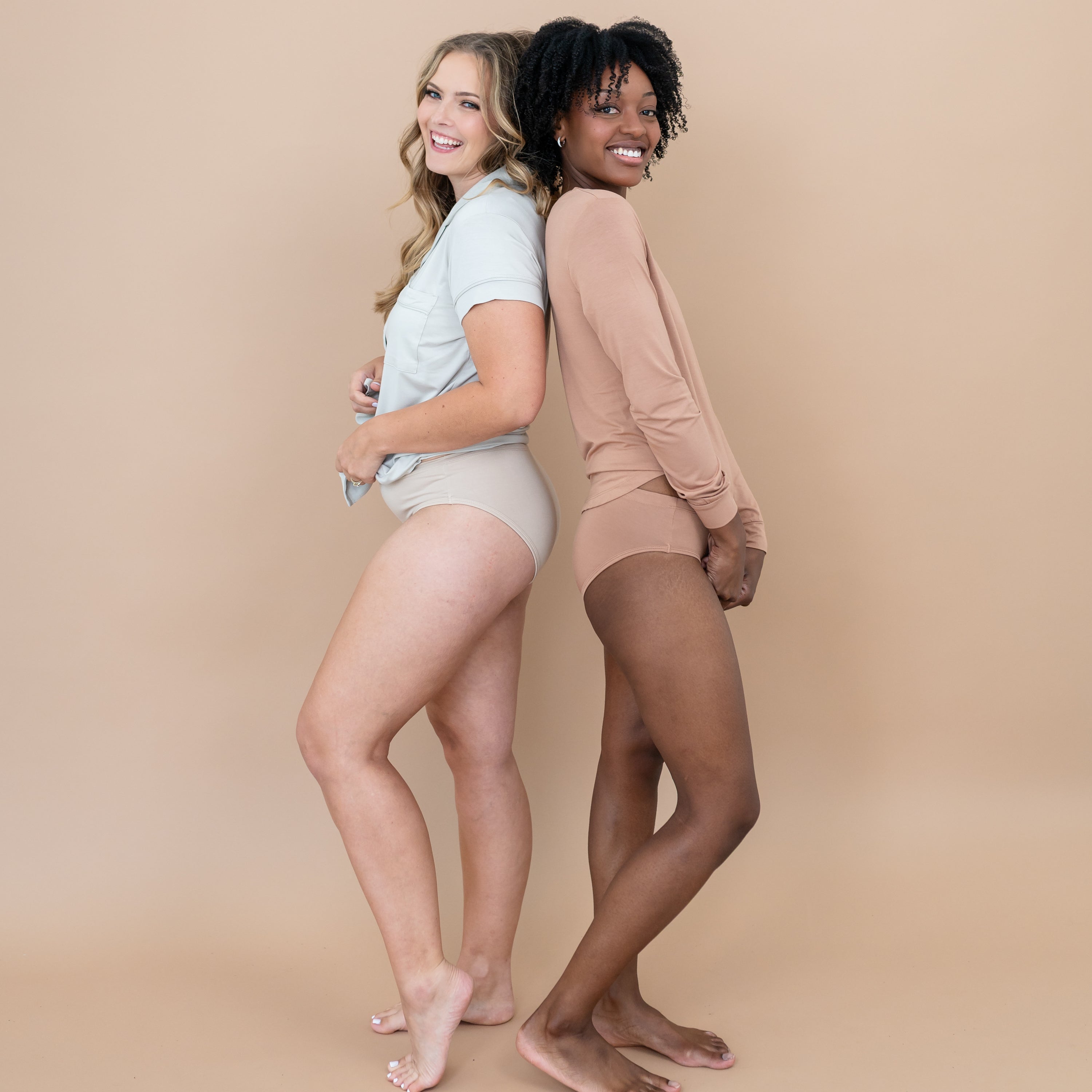 Two women standing back to back modeling the Women's underwear in Bisque and Latte