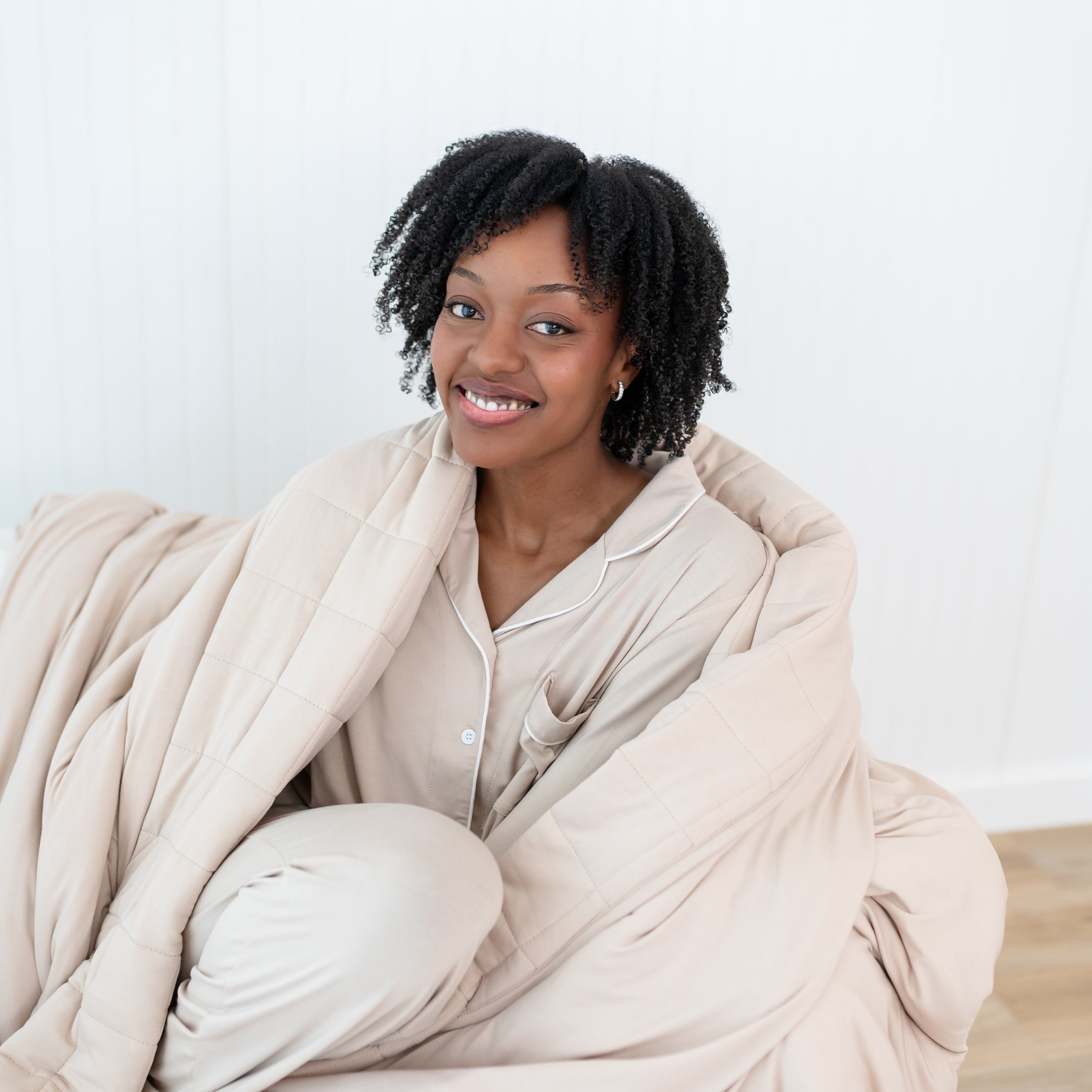 Close up of female model wrapped in an Adult Quilted Blanket in Bisque 2.5
