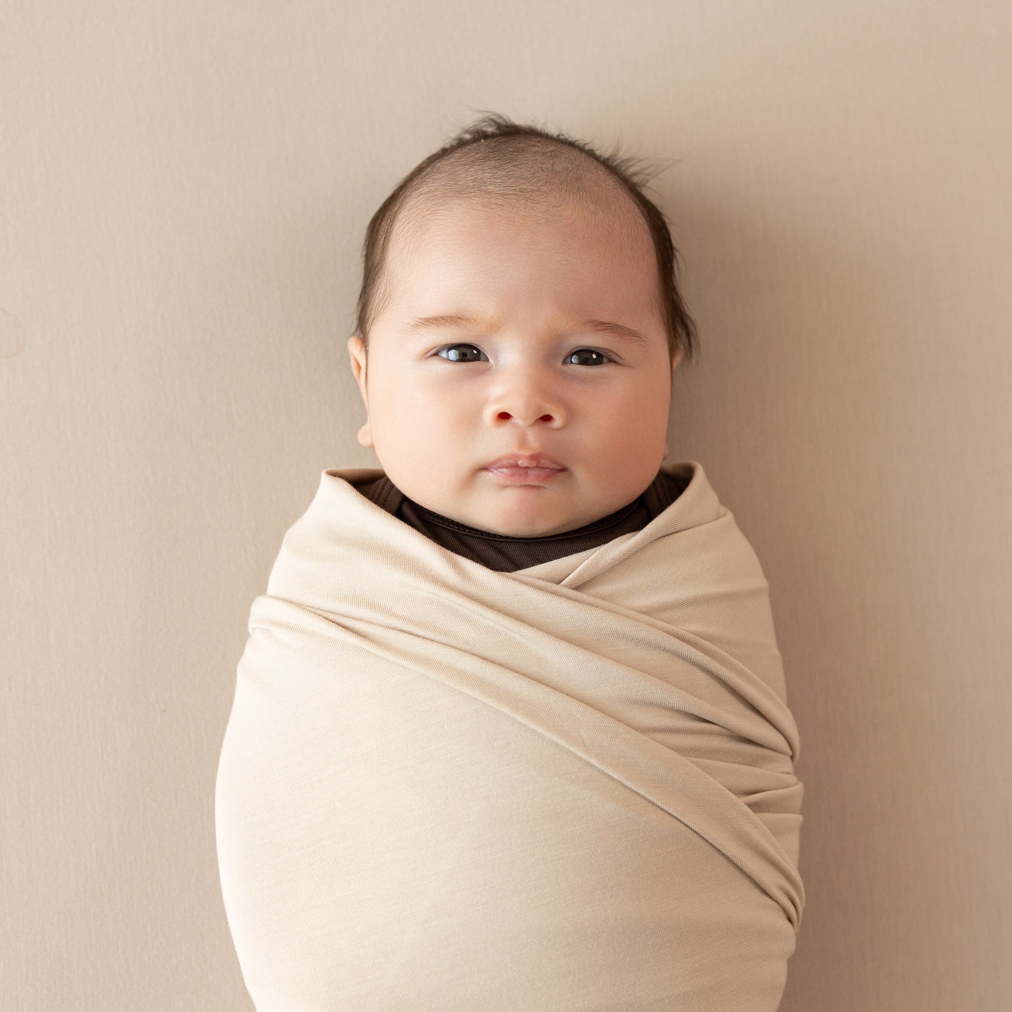 Close up of newborn swaddled in the Swaddle Blanket in Bisque
