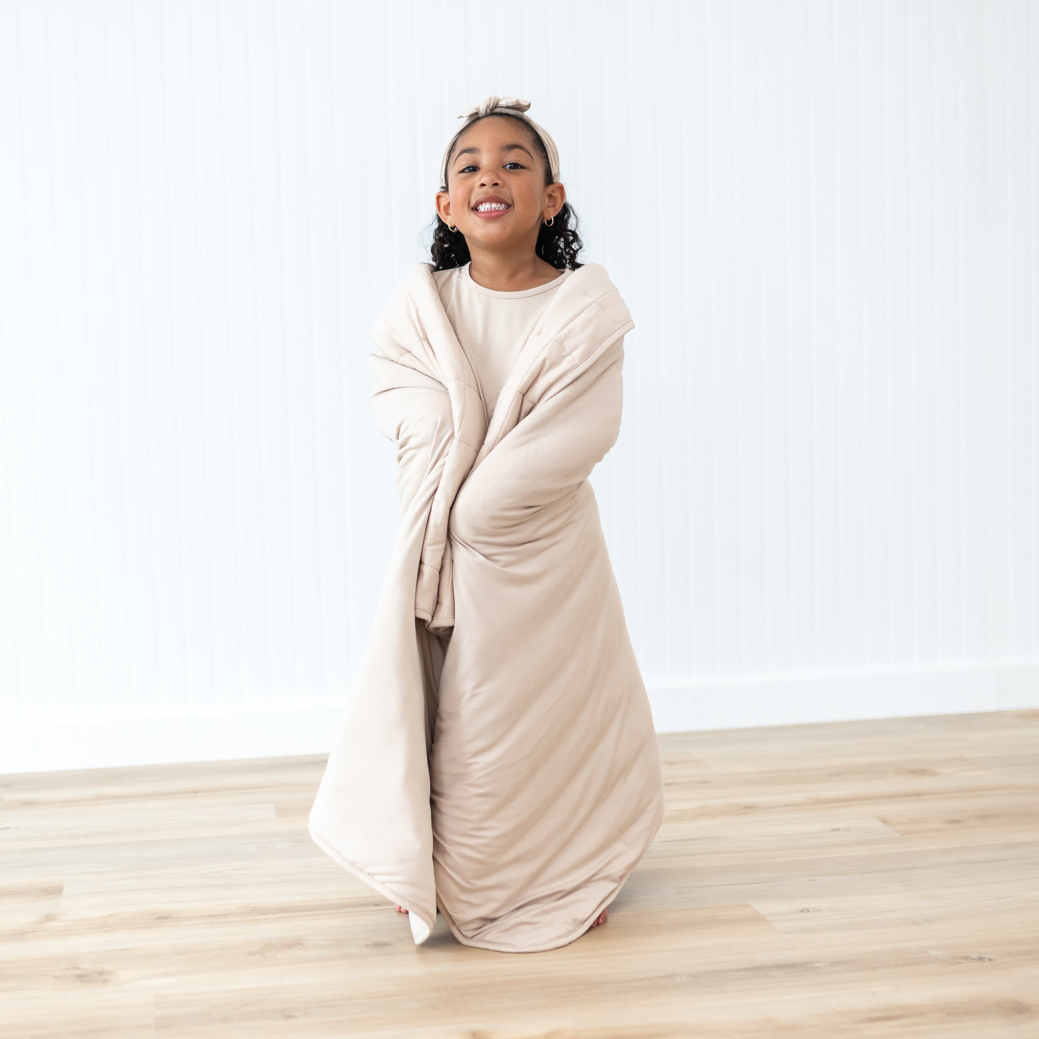 Young girl model standing wrapped in a Toddler Blanket in Bisque 2.5