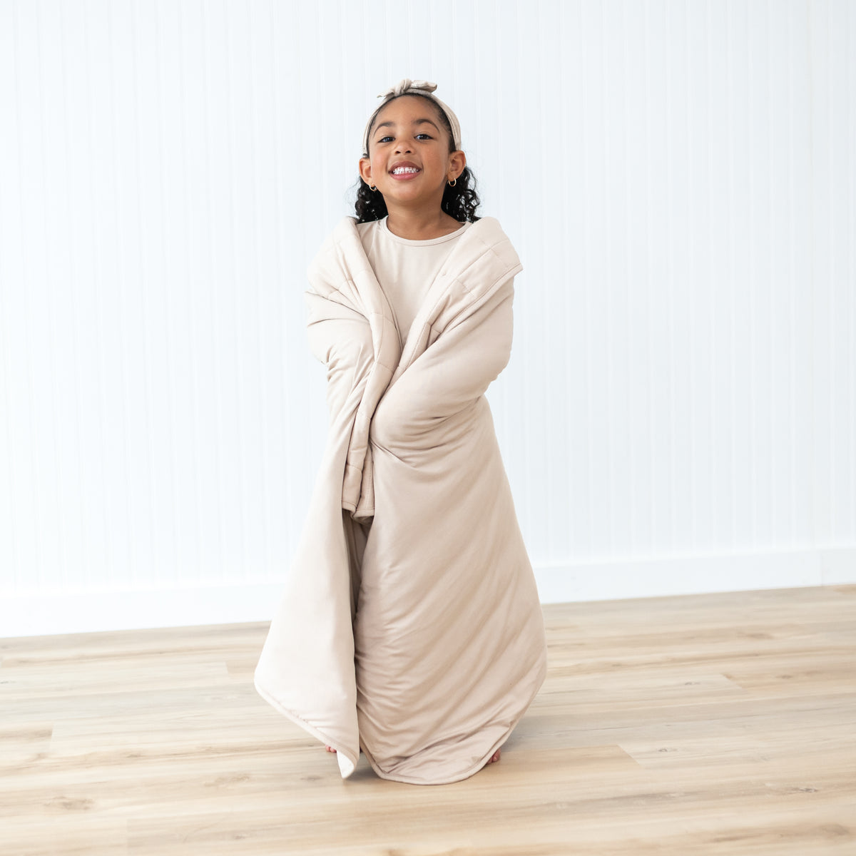 Young girl model standing wrapped in a Toddler Blanket in Bisque 2.5