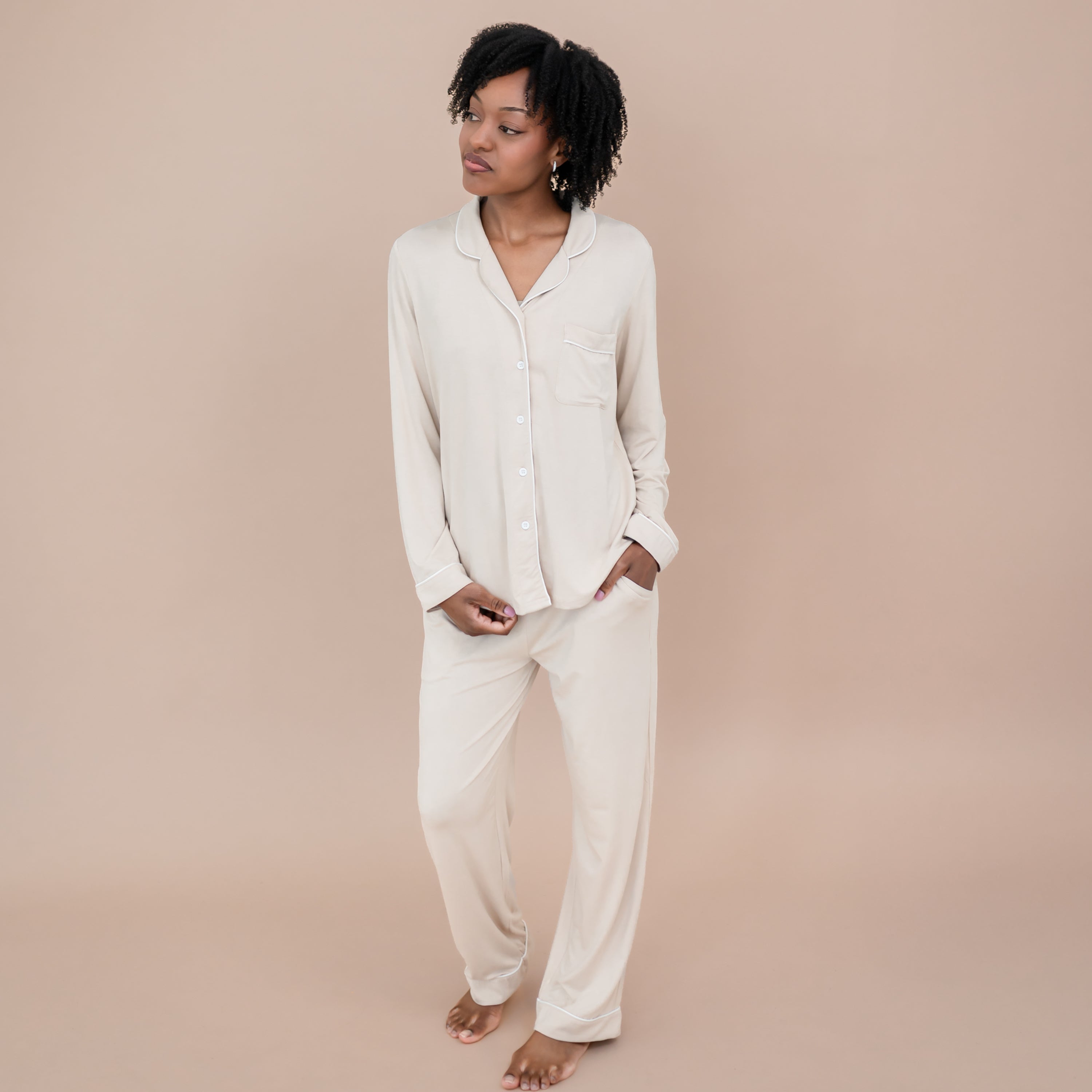 Female model wearing the Long-Sleeved Women's Pajama Set in Bisque with Cloud Trim with one hand in the pants pocket
