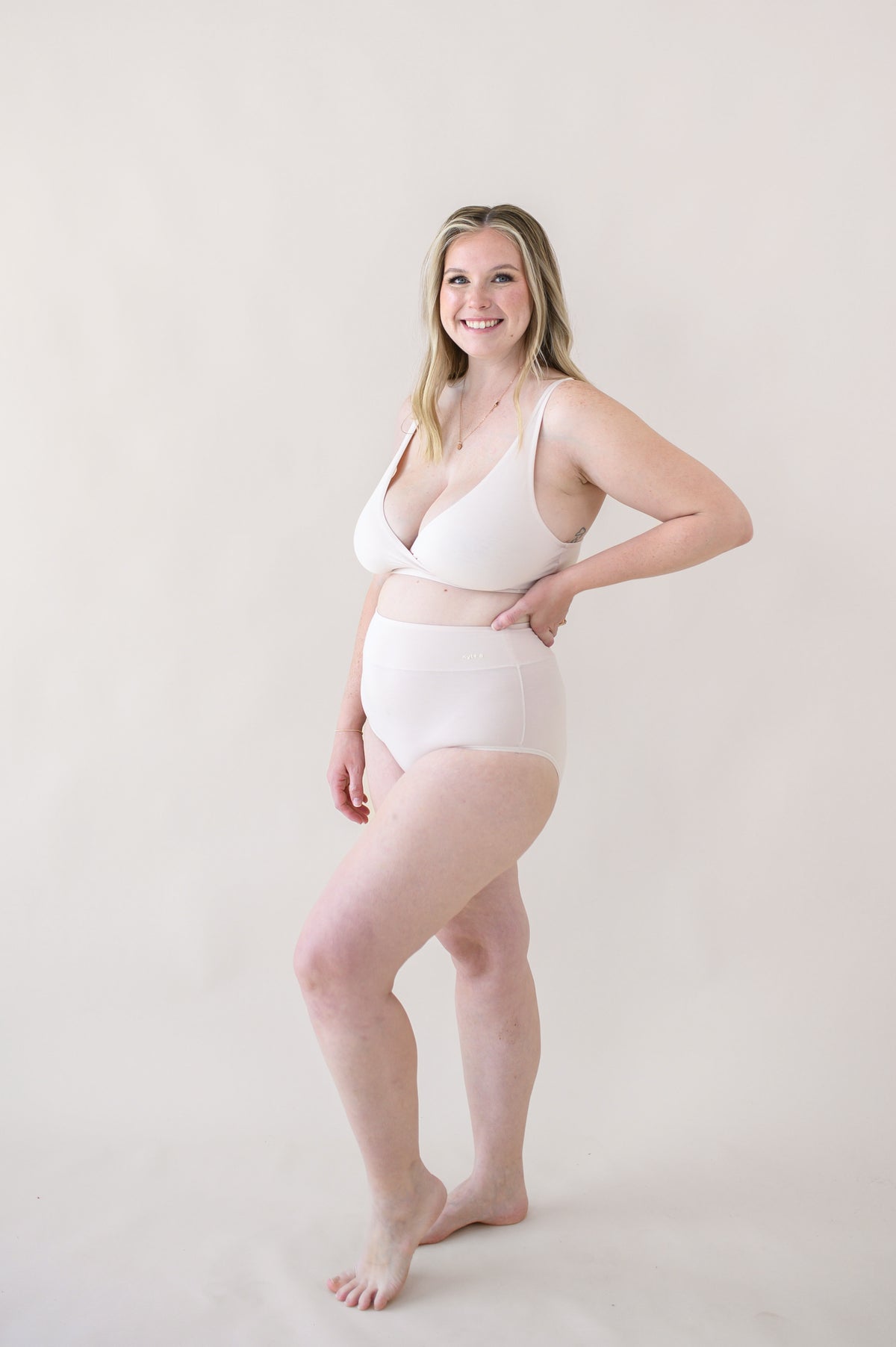 Female modeling the Women's High-Waisted Brief in Blonde with matching cross front bralette
