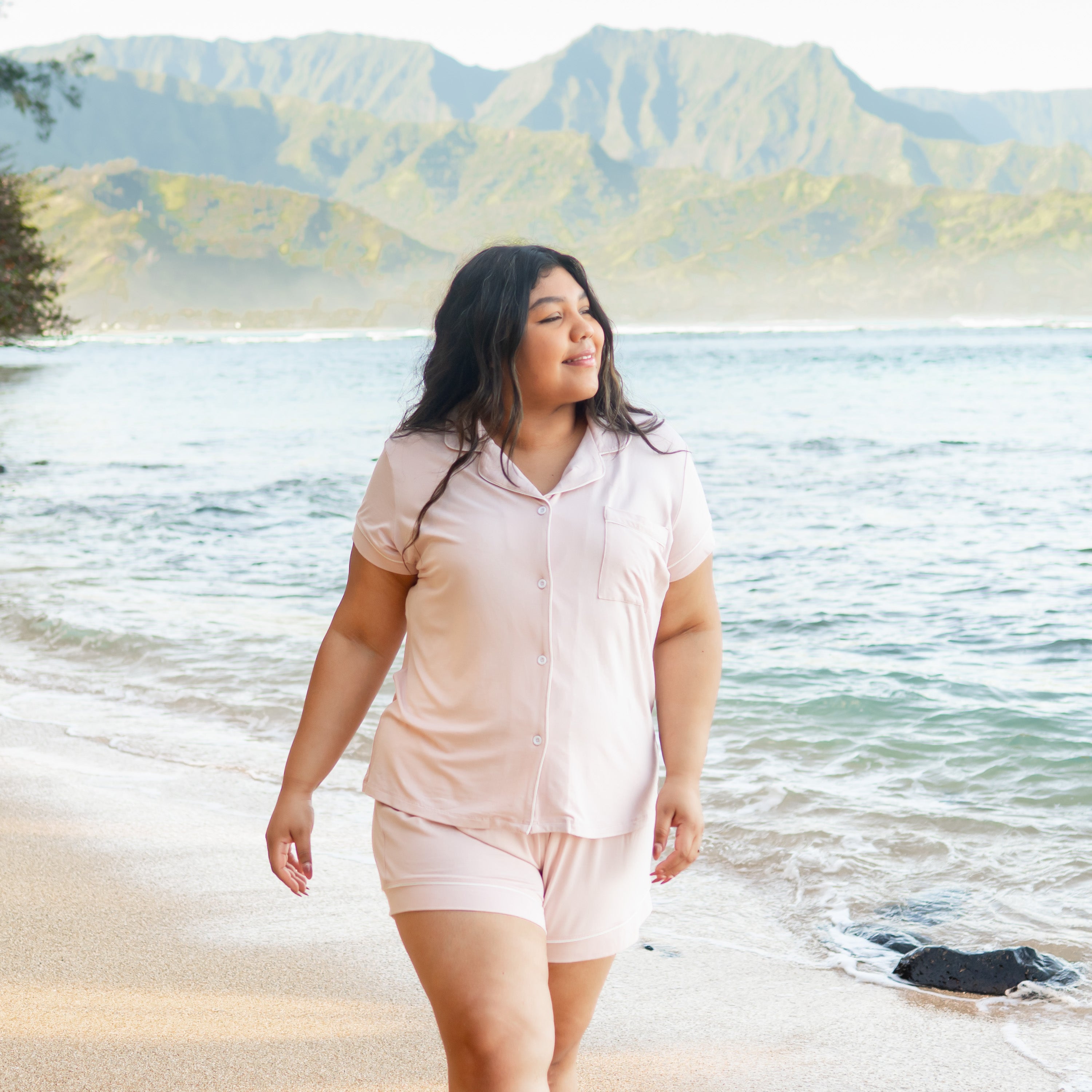 Woman modeling Women’s Short Sleeve Pajama Set in Blush with Cloud Trim on beach