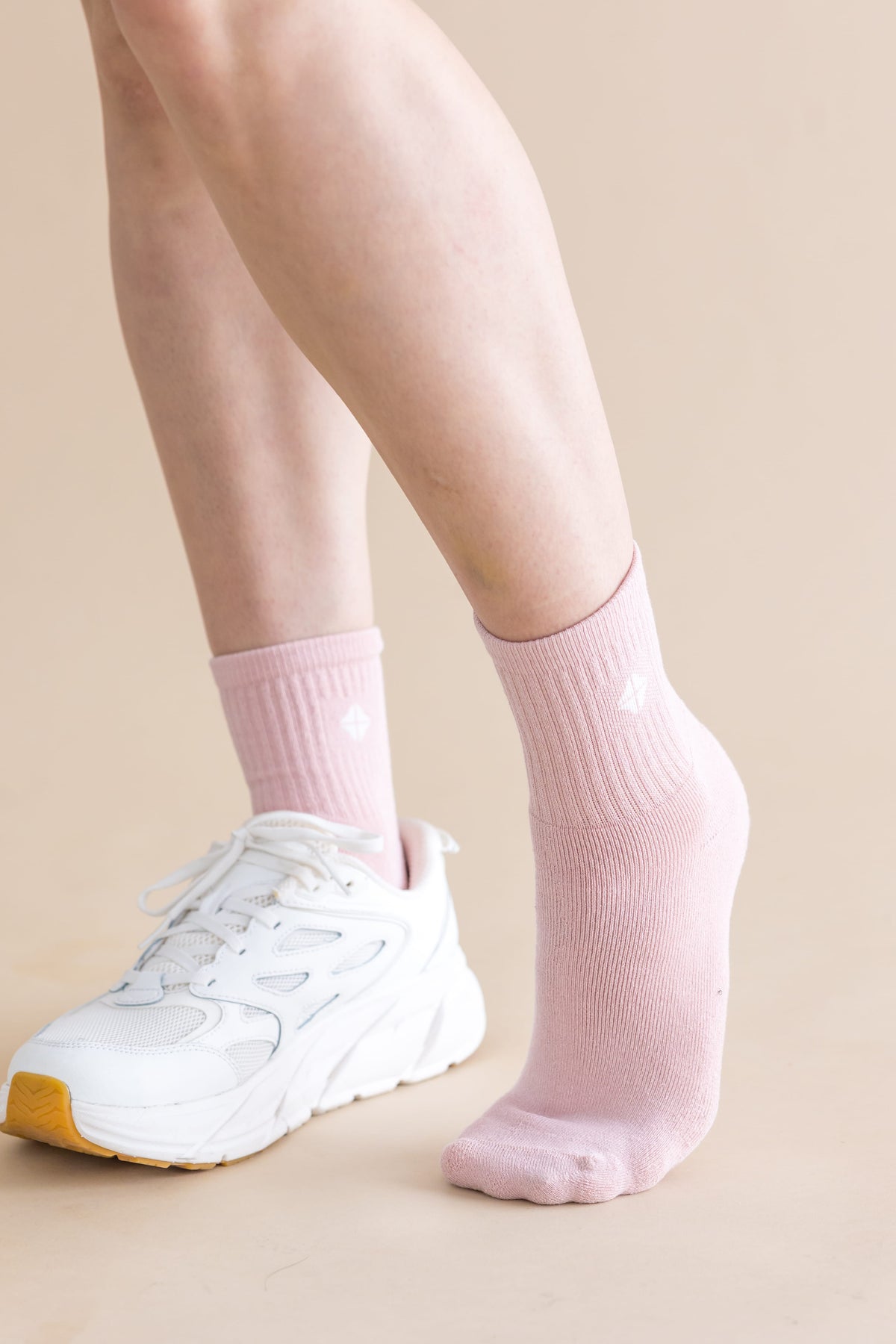 Adult Crew Socks in Blush shown on a models feet with one white sneaker on