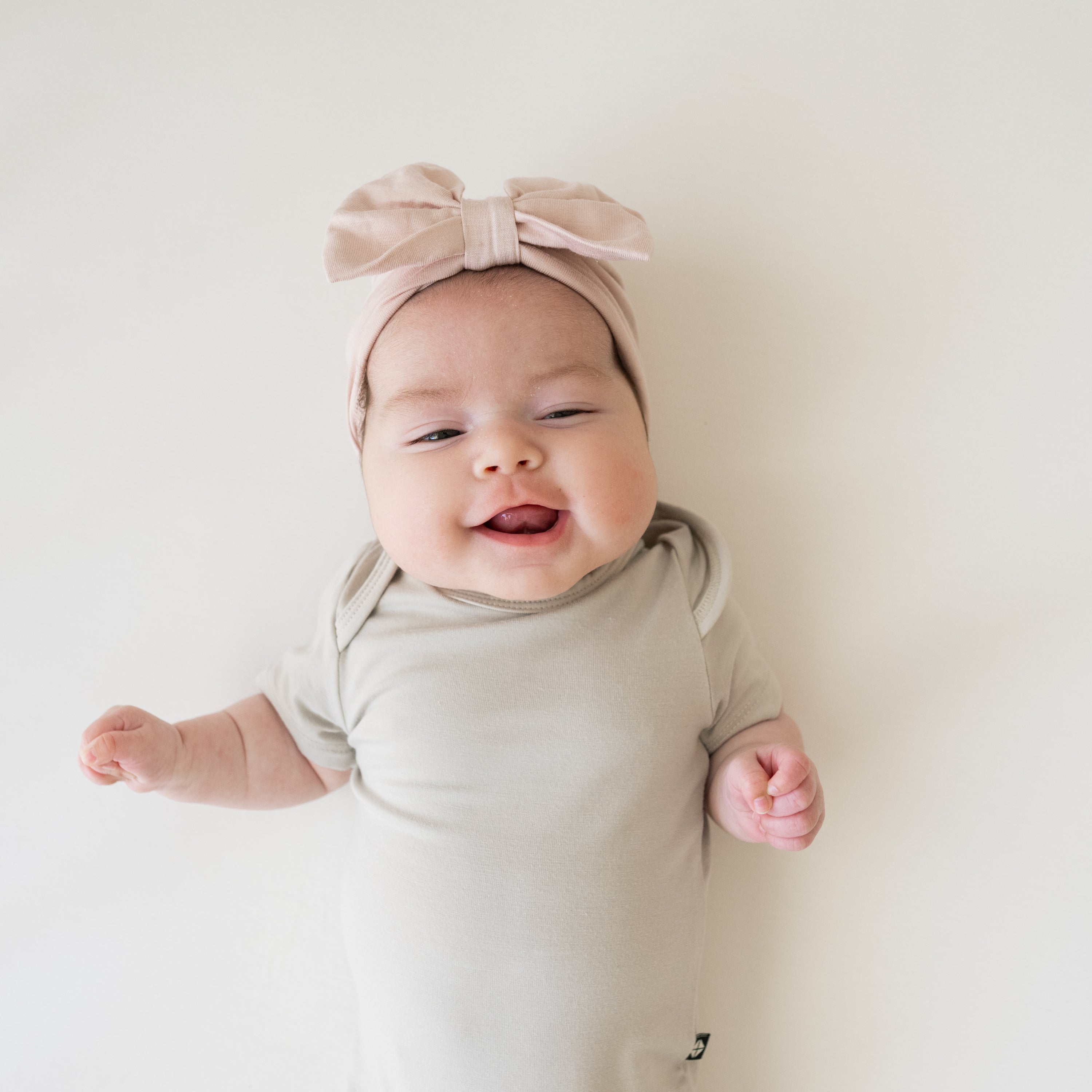 Baby wearing Bow Headwrap hat in Blush pink