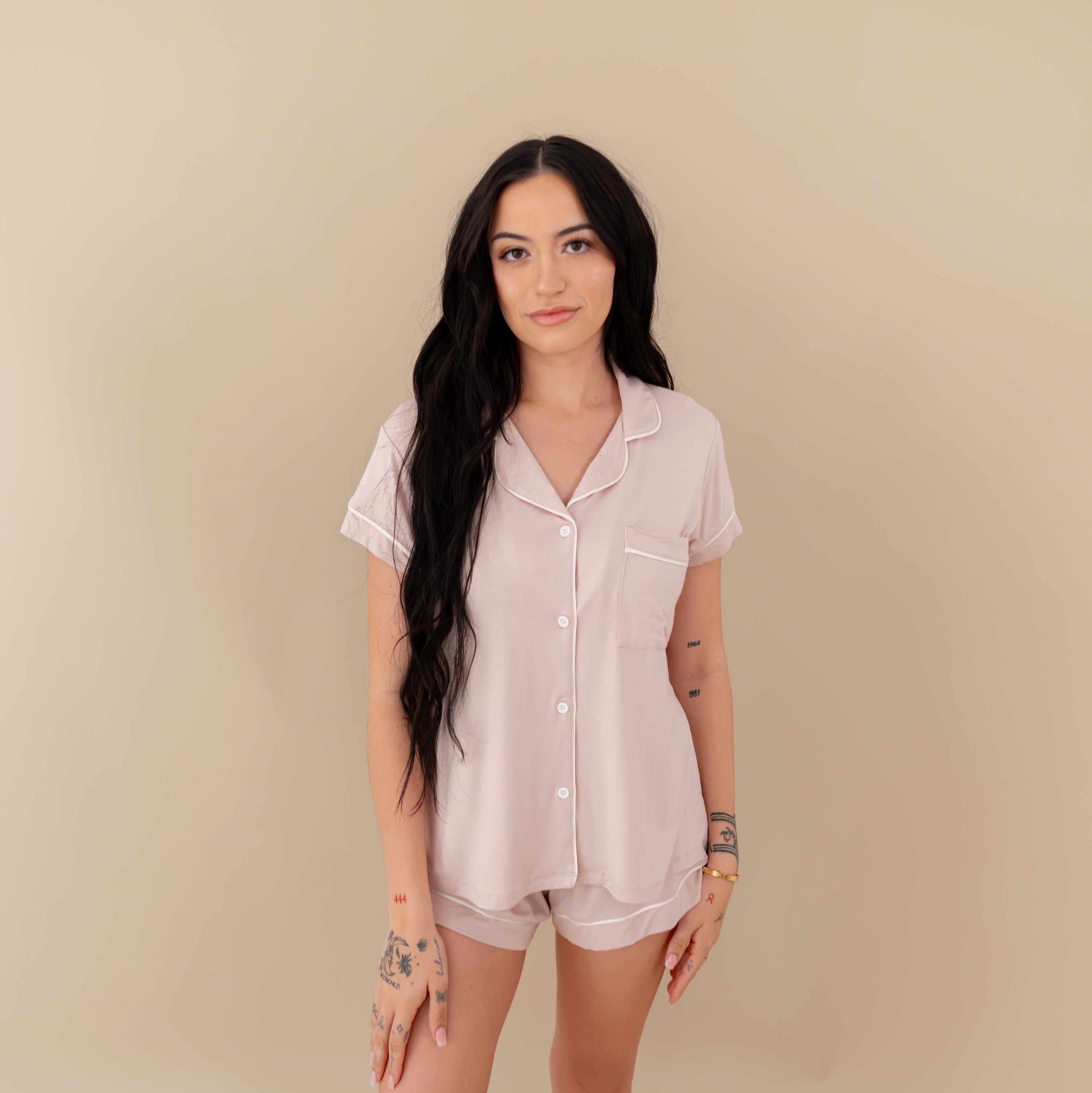 Woman modeling Women’s Short Sleeve Pajama Set in Blush with Cloud Trim against a tan backdrop