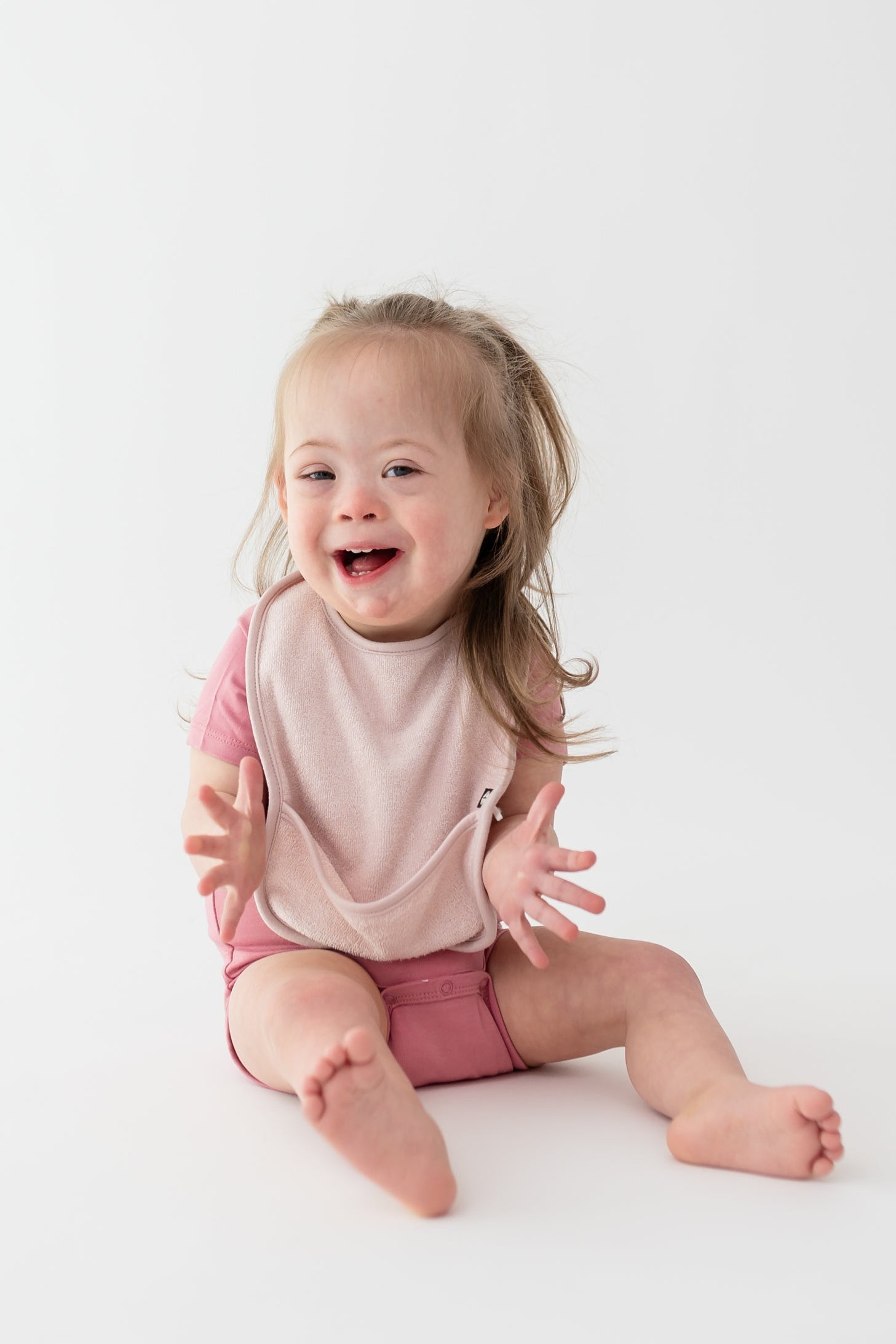 Toddler wearing Terry Pocket Bib in Blush Pink