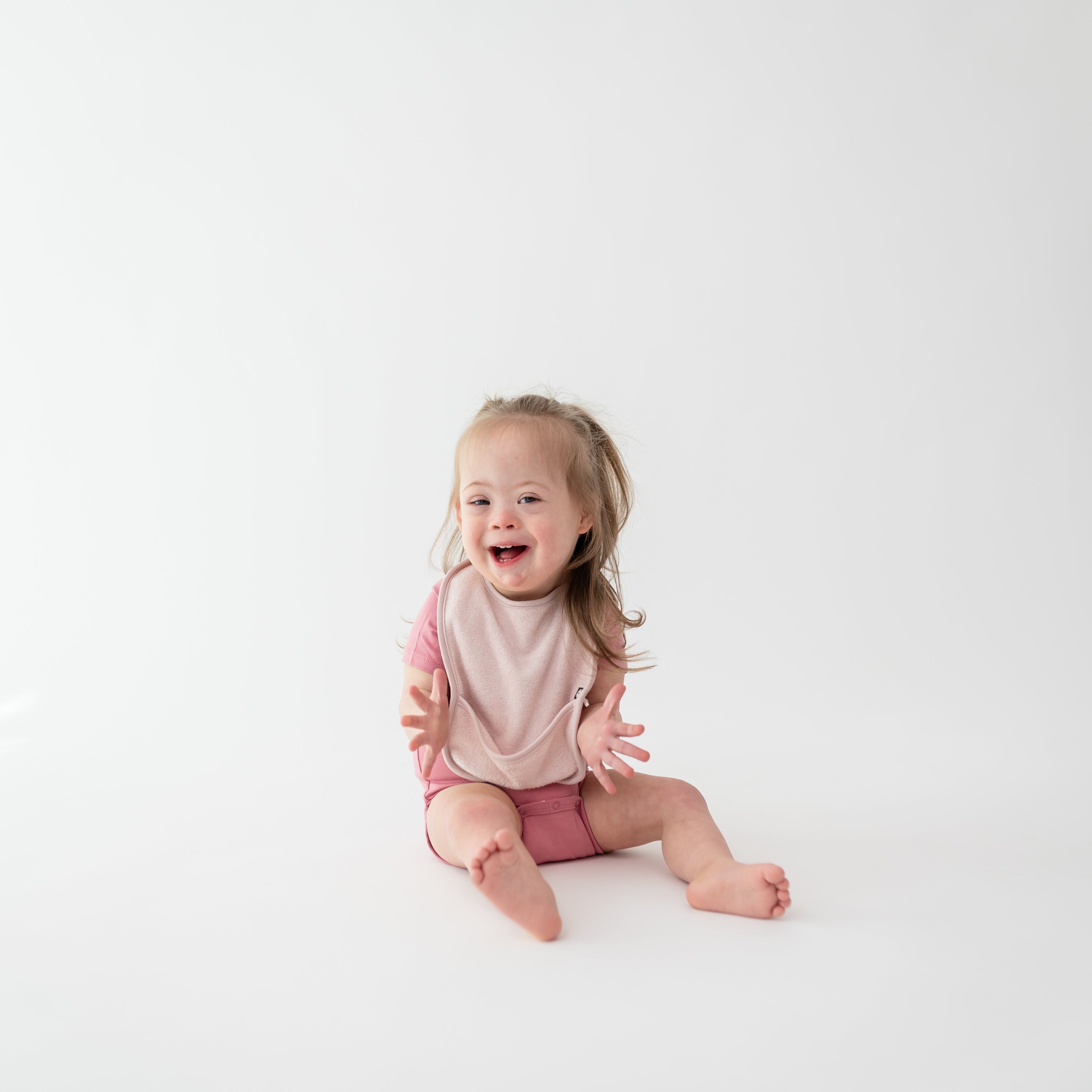 Toddler wearing Terry Pocket Bib in Blush Pink