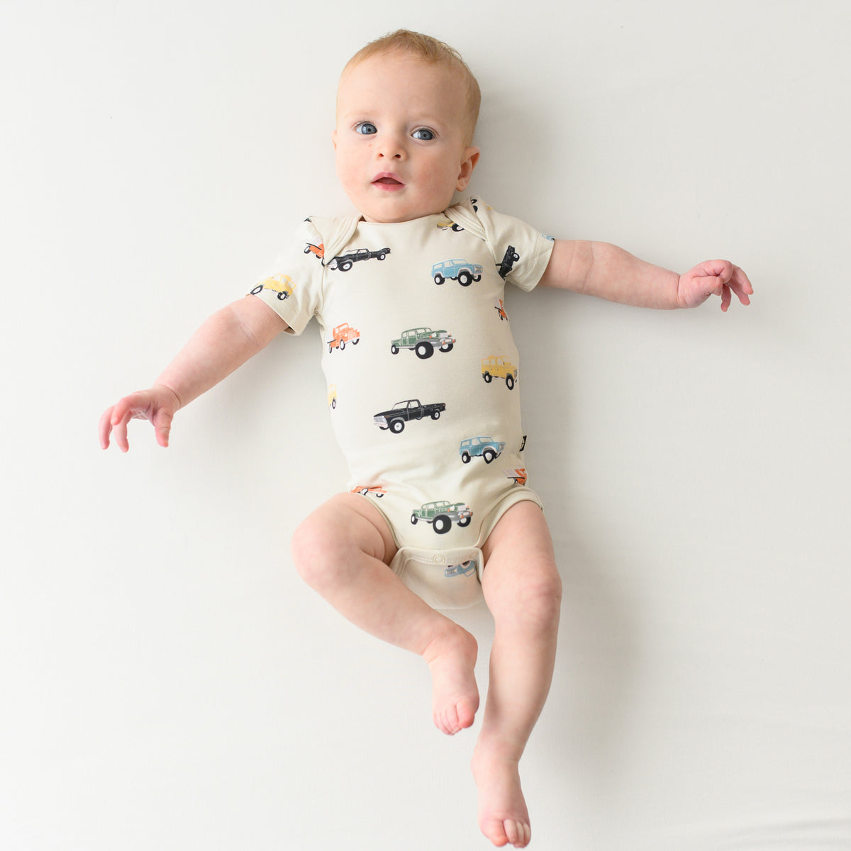 Baby wearing infant bodysuit in Vintage Truck