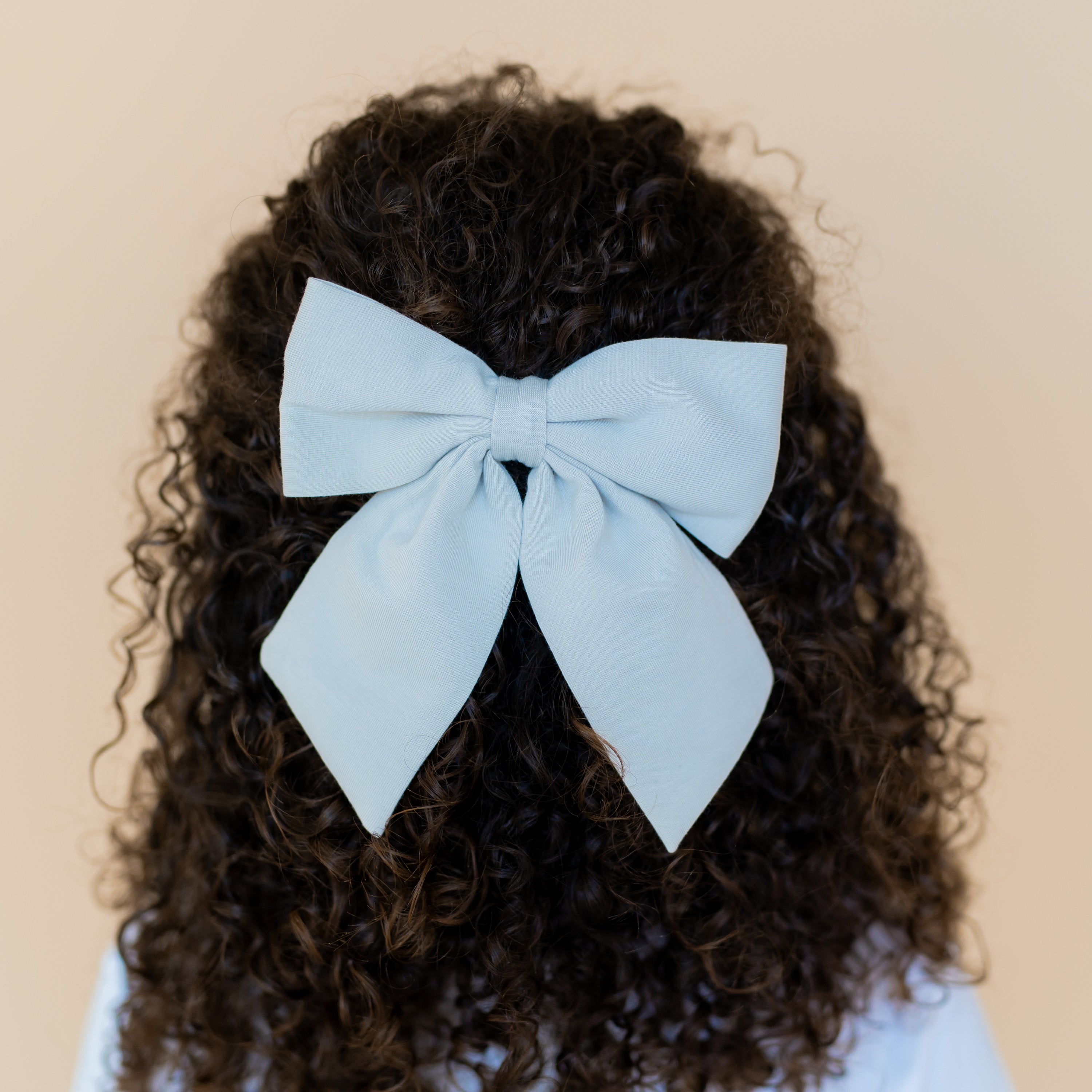 Large Alligator Clip Bow in Breeze shown in a young girls hair