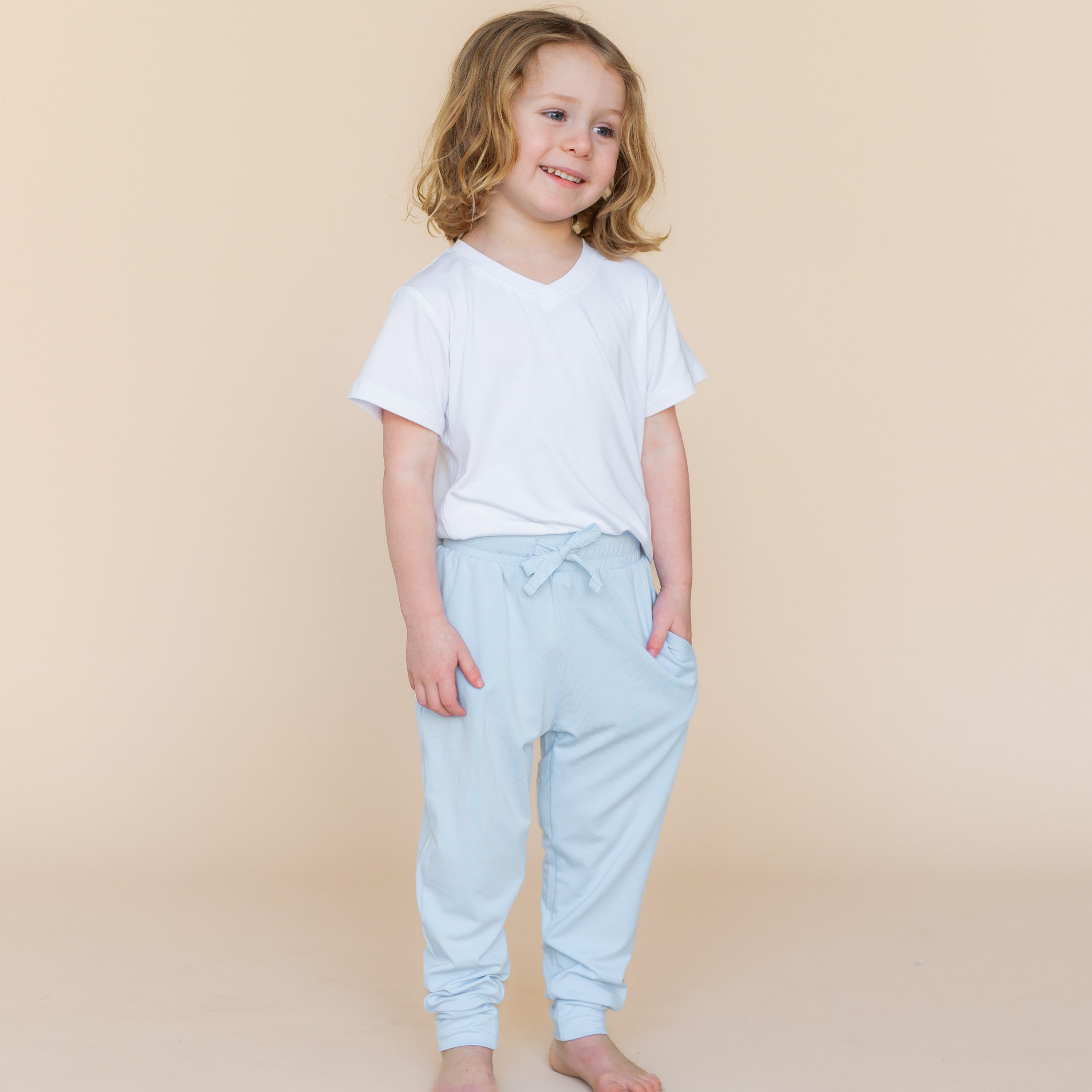 Young child wearing the Toddler Jogger Pant in Breeze with a white toddler v-neck