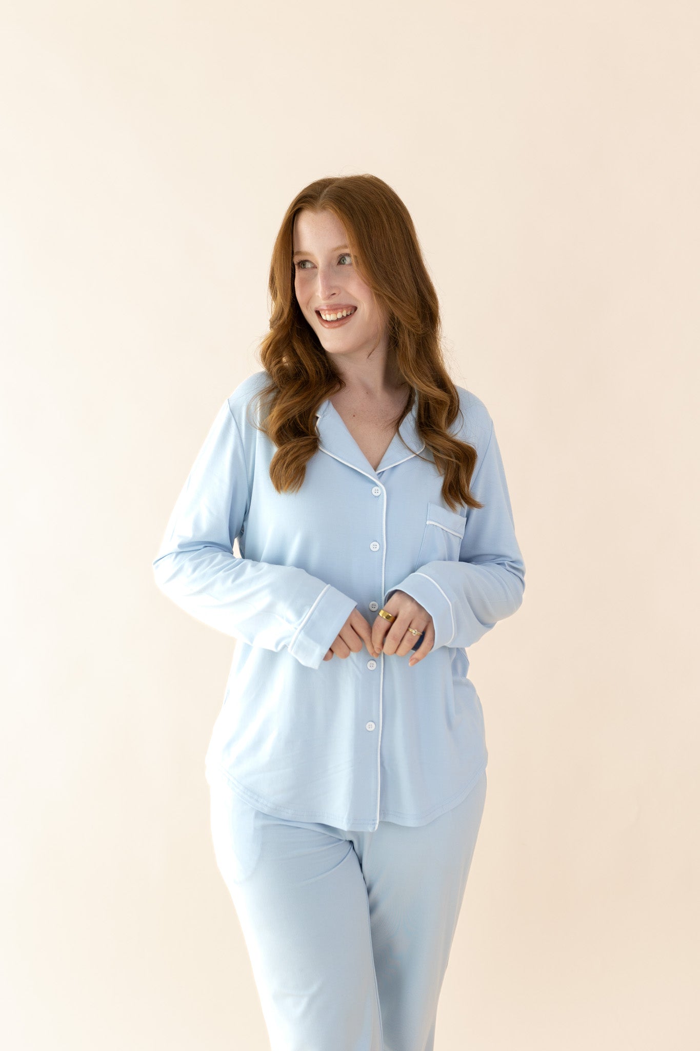 Smiling model wearing the Long-Sleeved Women's Pajama Set in Breeze