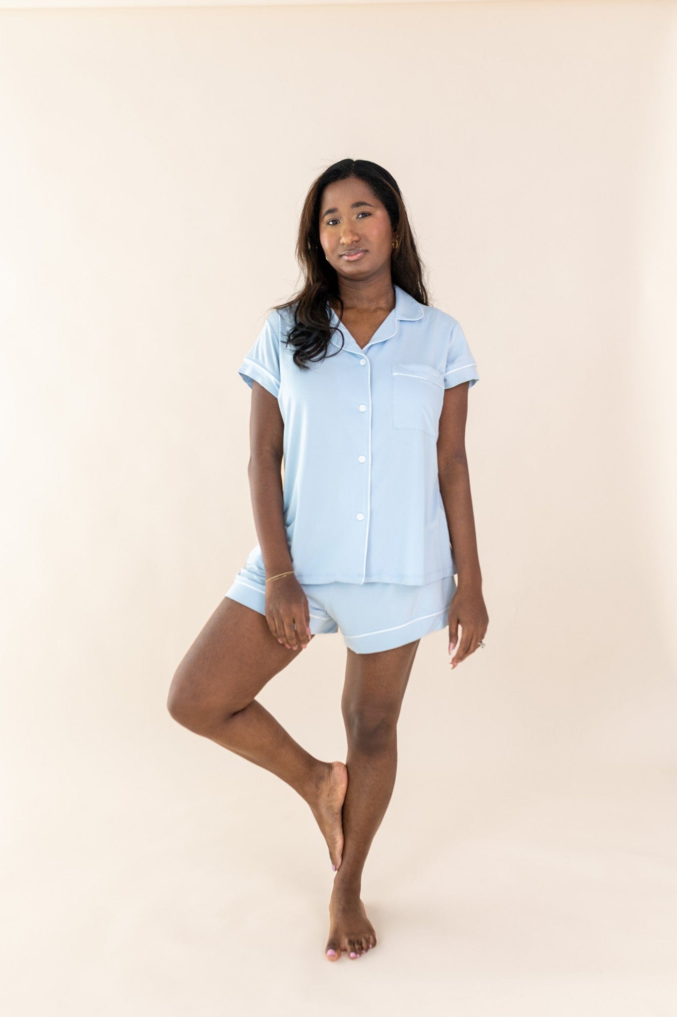 Female posing wearing the Women's Short Sleeve Pajama Set in Breeze in front of a light neutral background