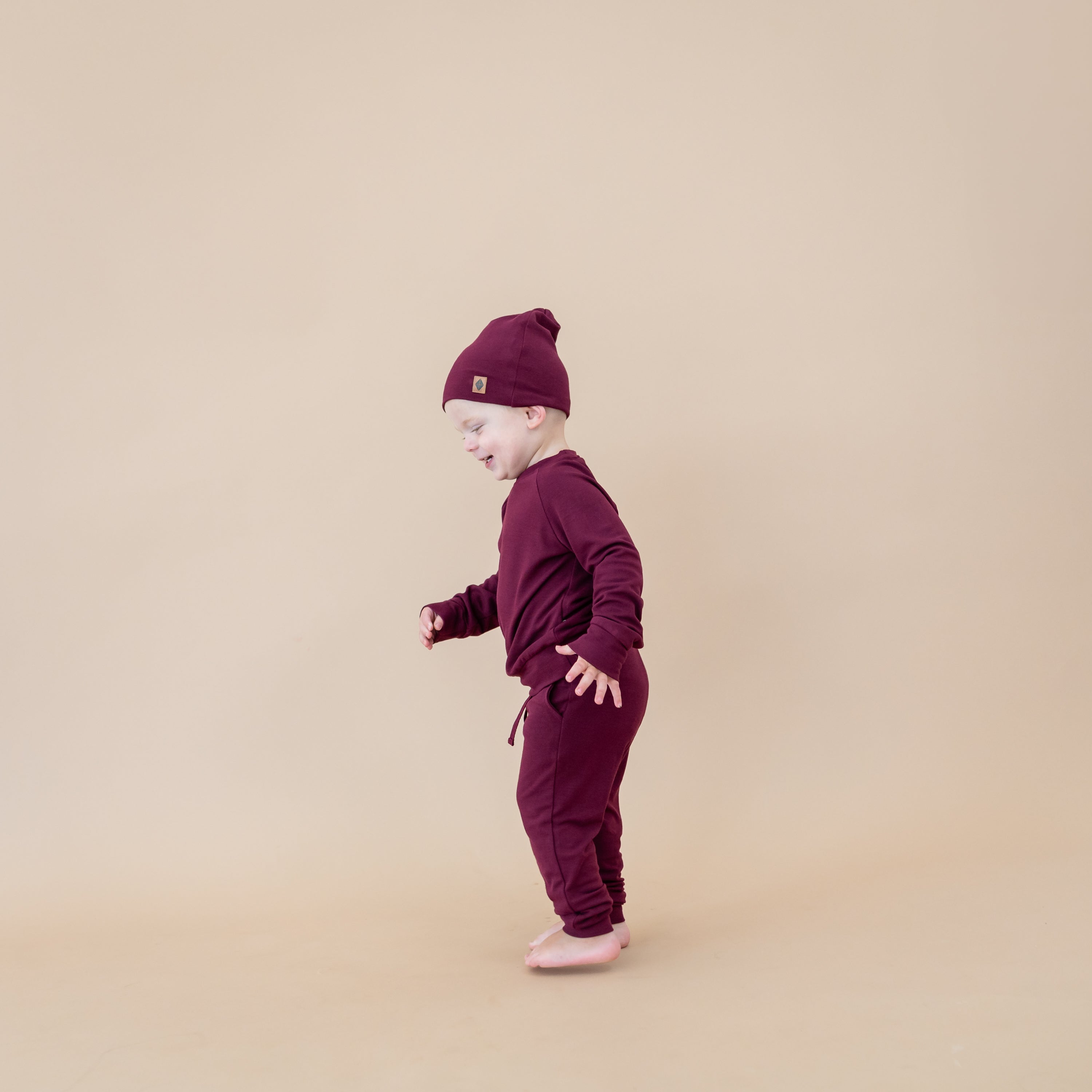 Toddler wearing Bamboo Jersey Beanie in Burgundy and matching jogger set