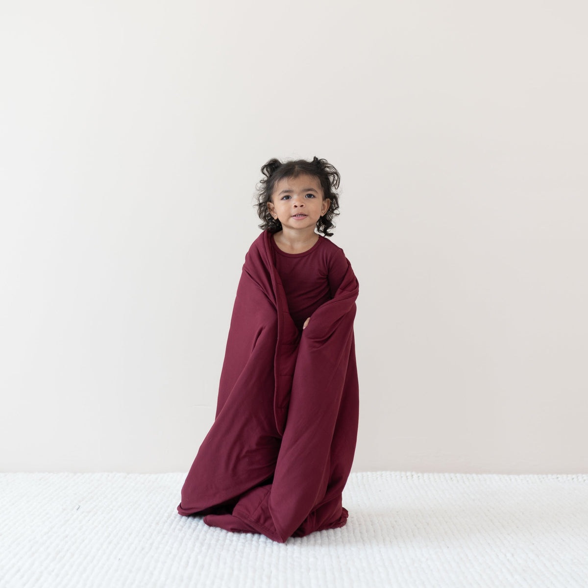 Toddler standing wrapped in the Toddler Blanket in Burgundy 2.5