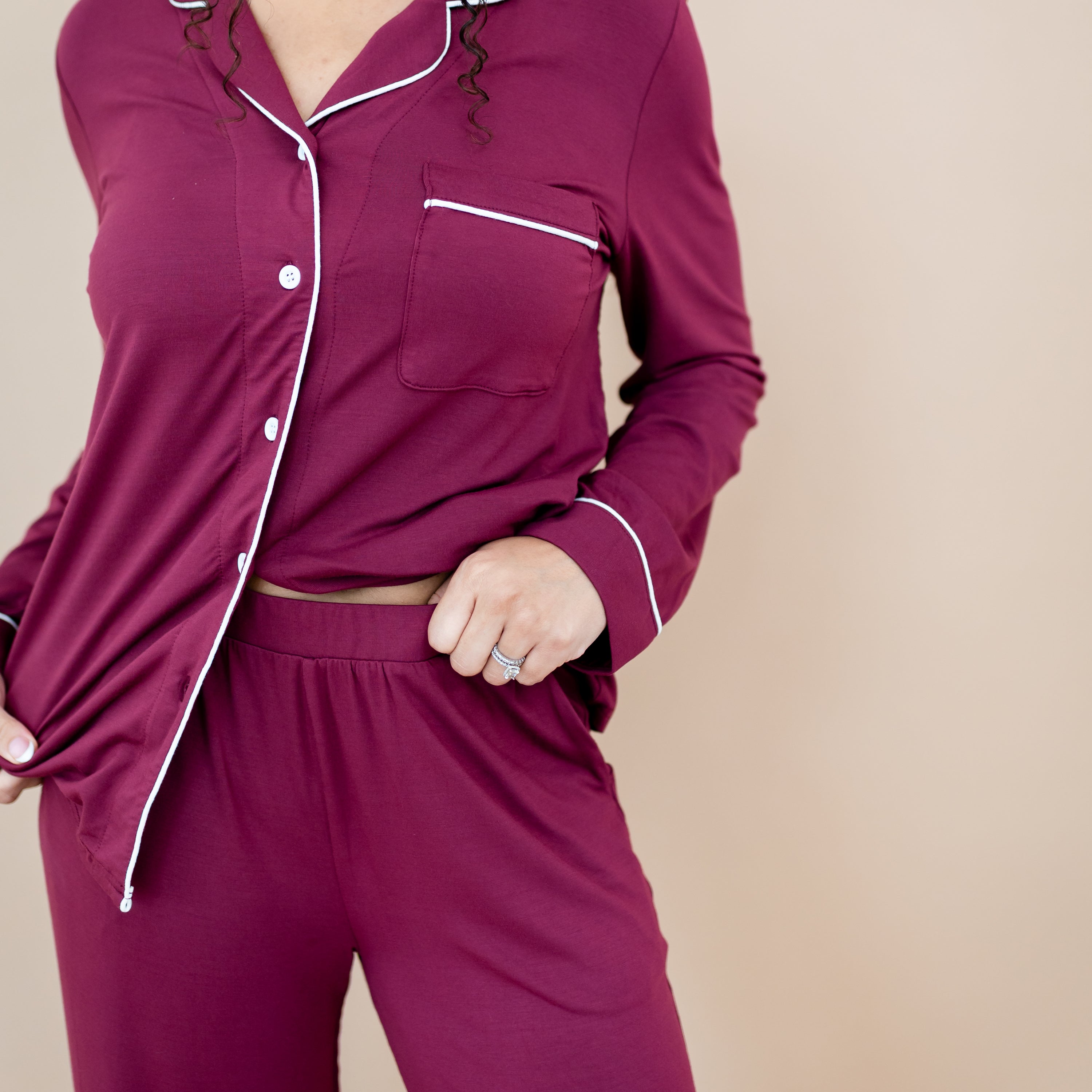 Close up of the elastic waistband on the Long-Sleeved Women's Pajama Set in Burgundy with Cloud Trim bottoms