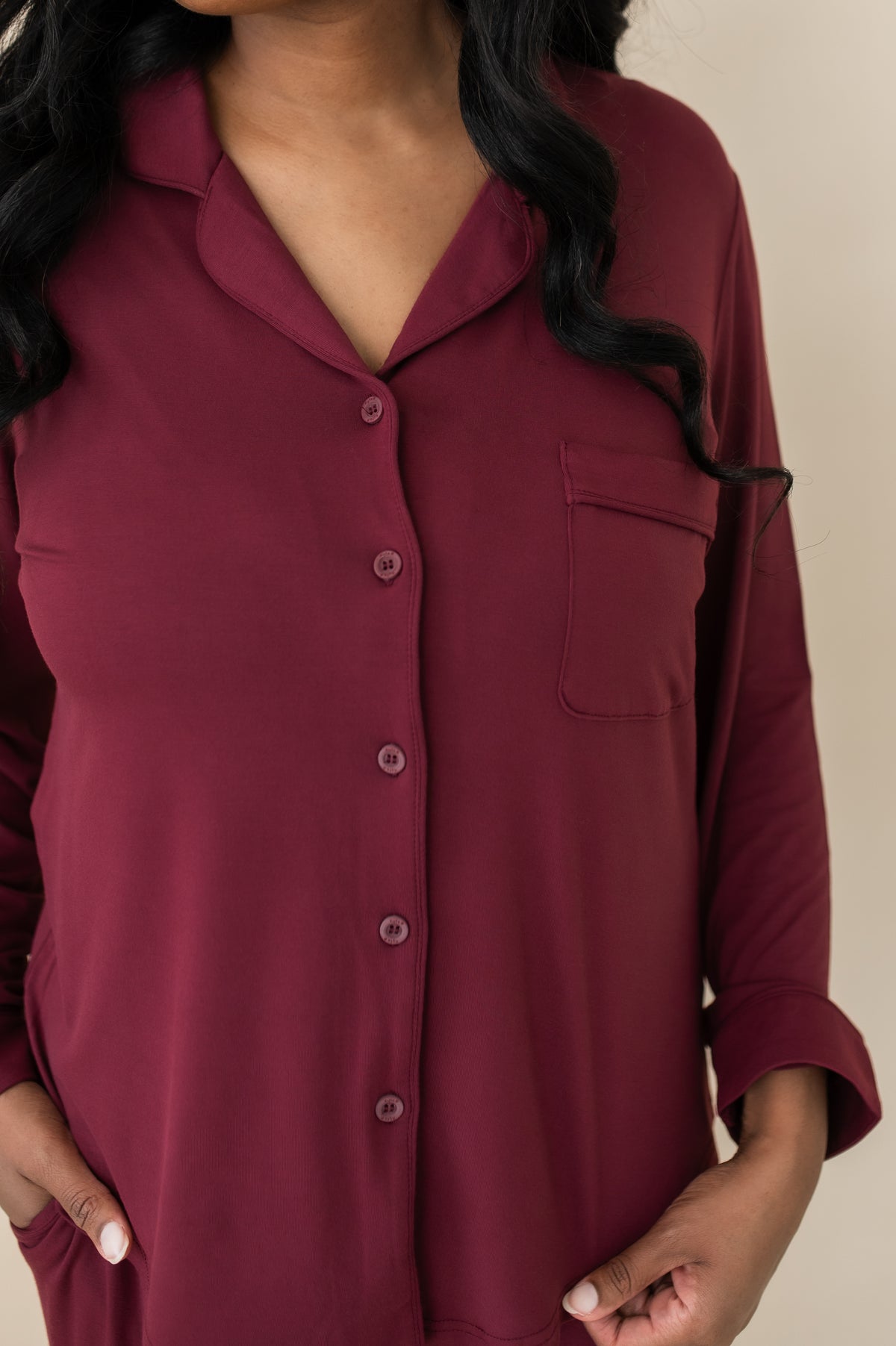 Close up of the button closure, burgundy trim and chest pocket on the shirt of the Long-Sleeved Women's Pajama Set in Burgundy with Burgundy Trim