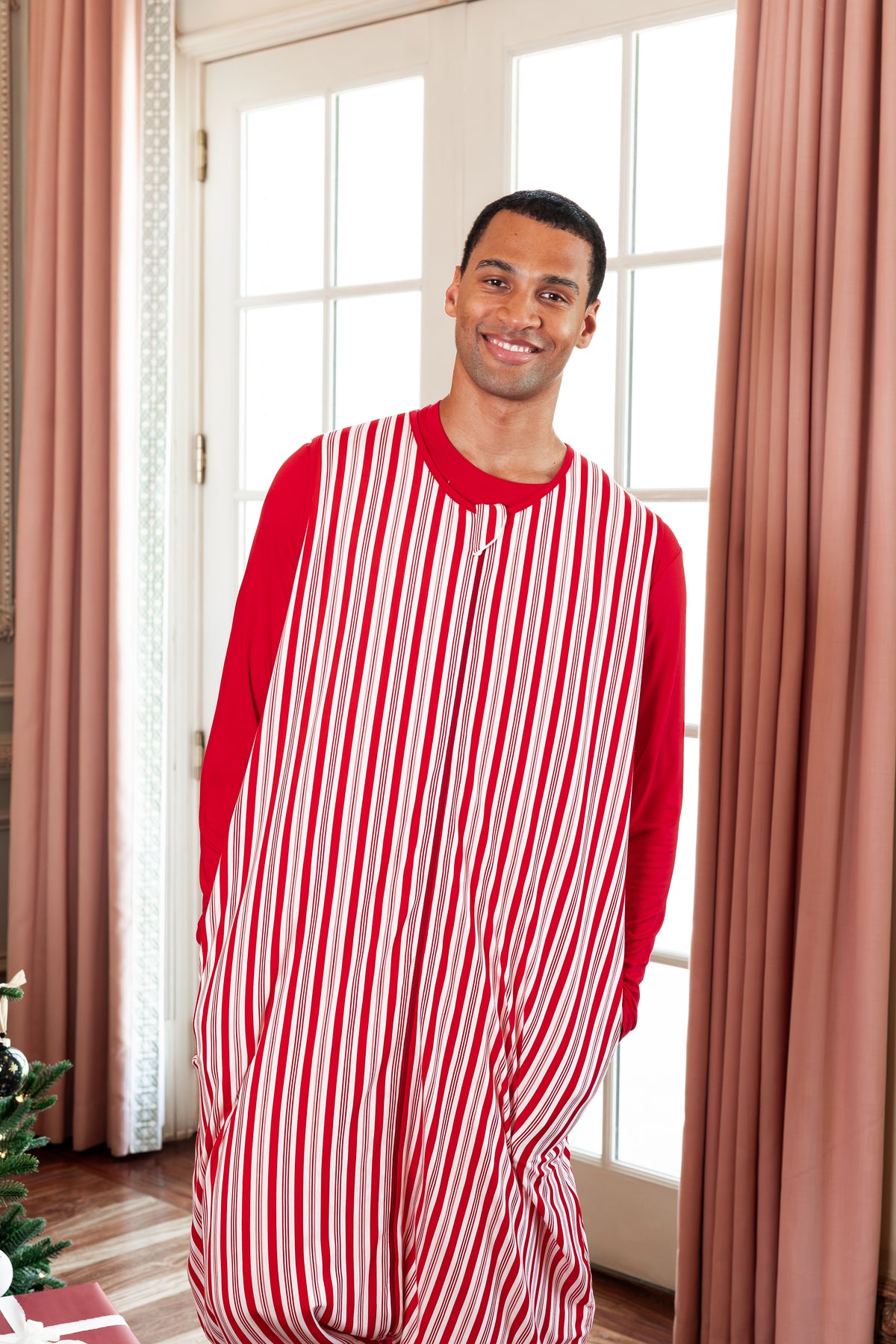 Modal wearing Adult Sleeveless Sleep Bag Walker in Peppermint Stripe print standing in a living room