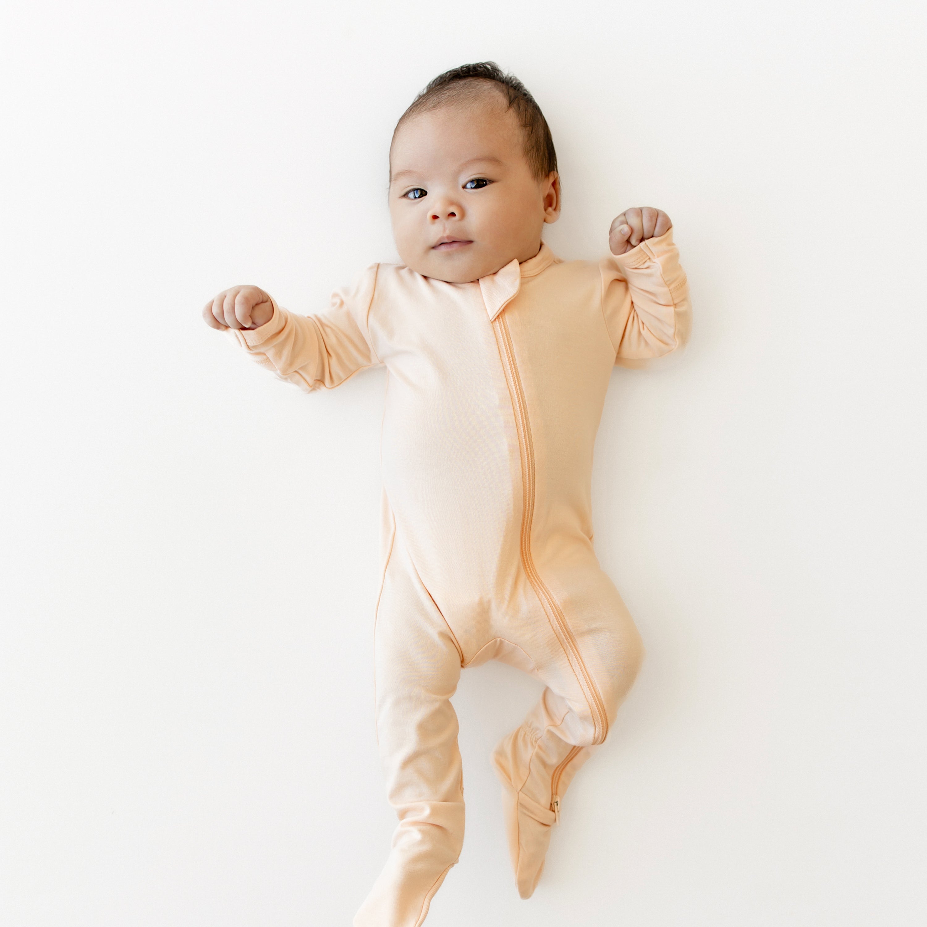 Infant wearing the bamboo Zippered Footie in Canyon