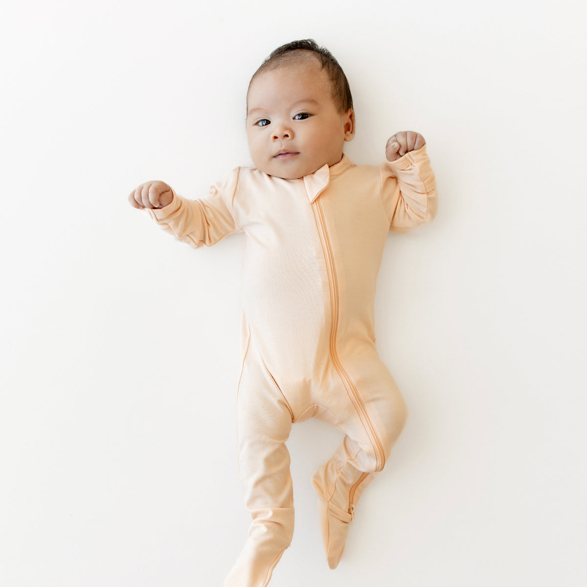 Infant wearing the bamboo Zippered Footie in Canyon